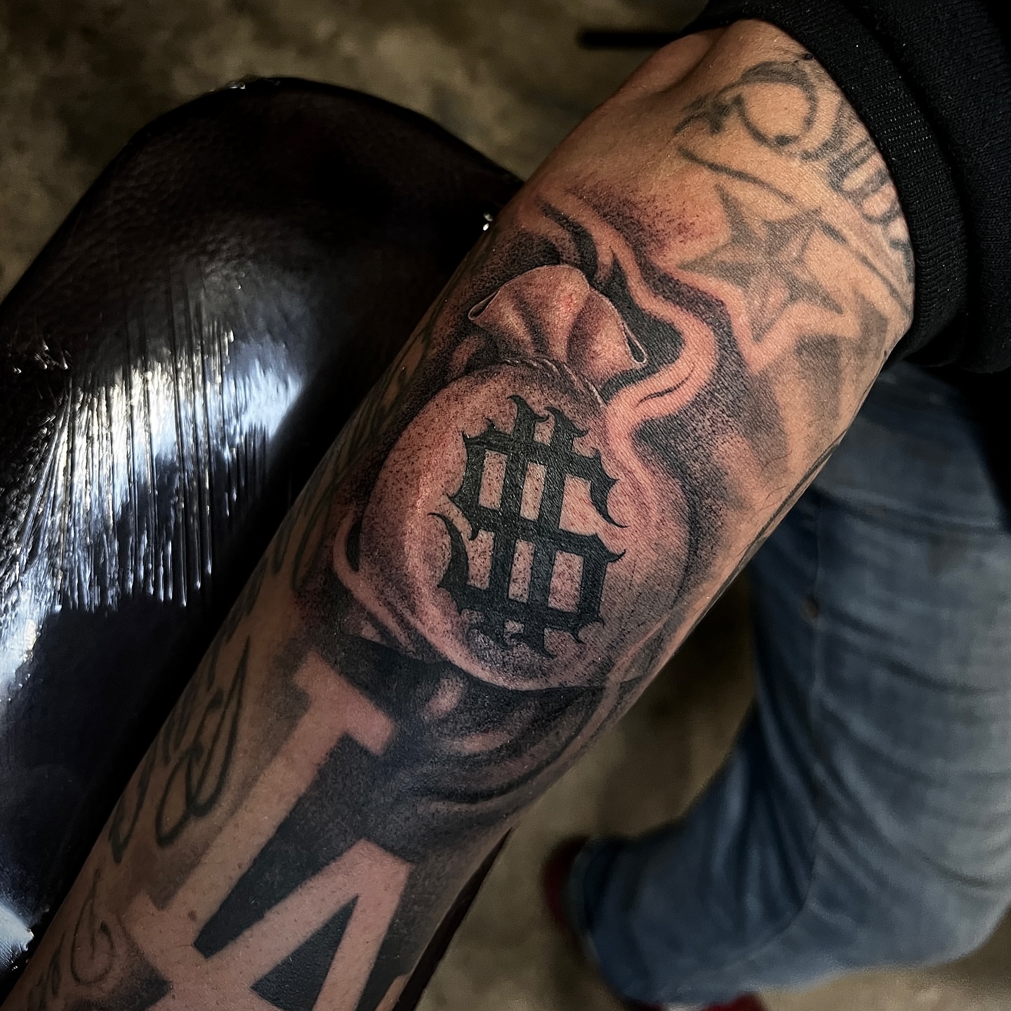 Heart with cross black and grey tattoo on the forearm by Joey Moreno