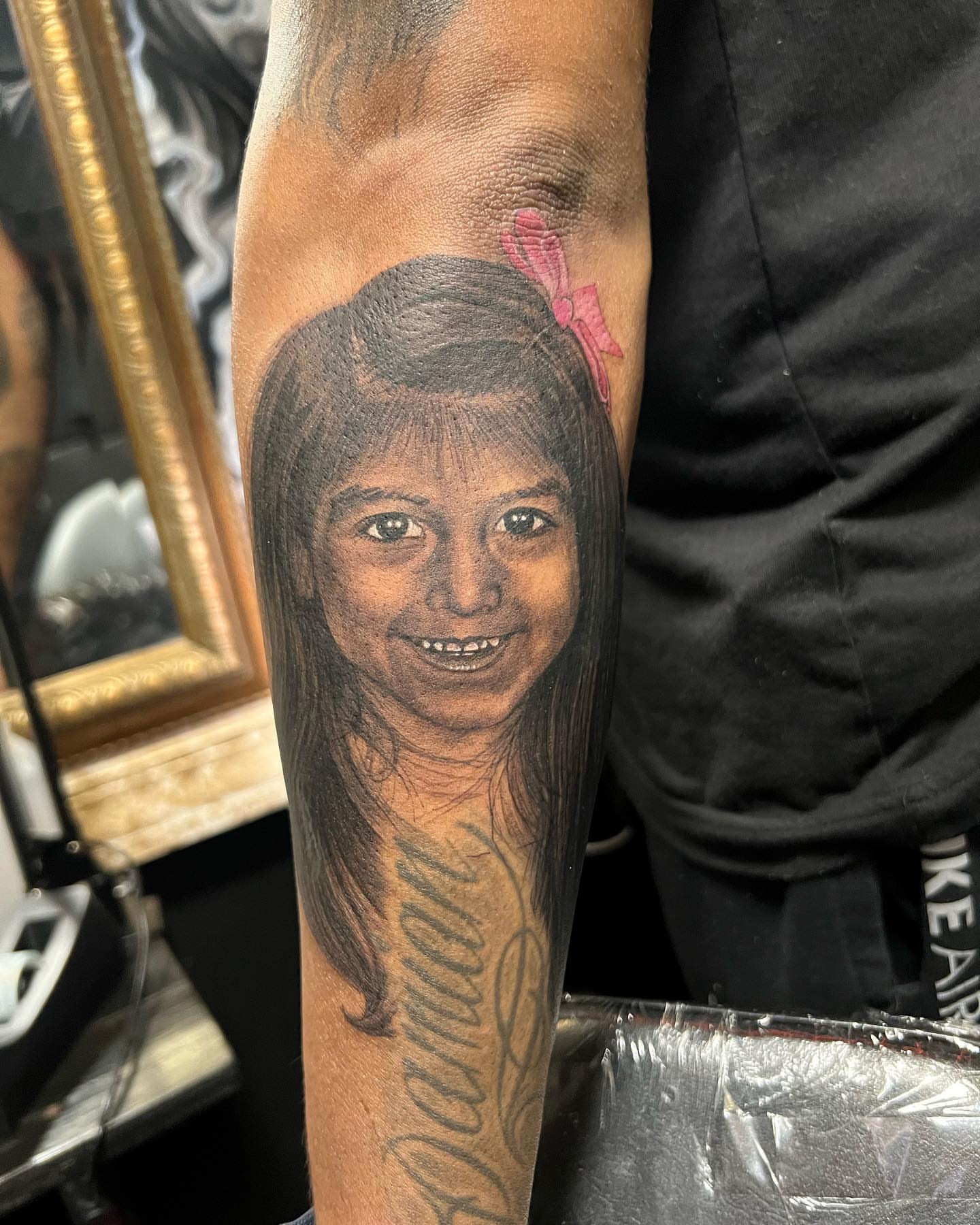 Child portrait realism tattoo on the forearm by JT Ink