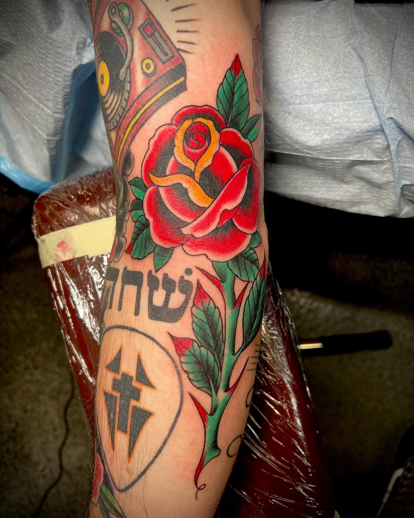 Rose American traditional tattoo on the forearm by Dustin Hysell