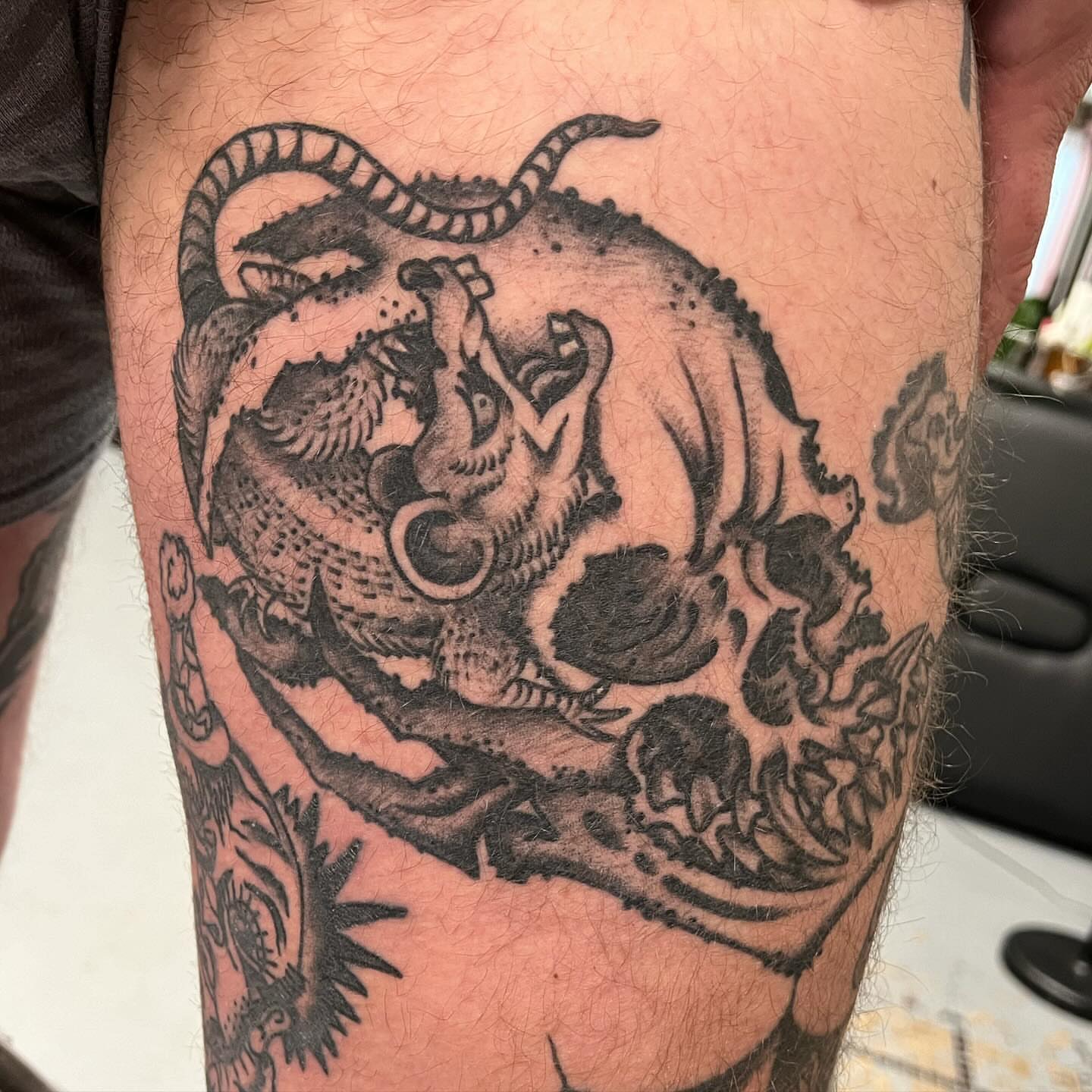 Dragon and skull realism tattoo on the thigh by Matt E.