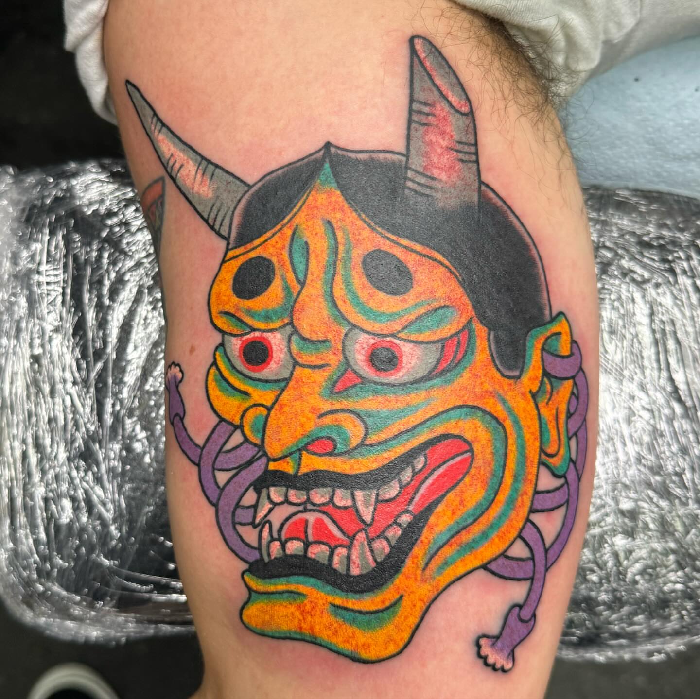 Demon mask American traditional tattoo on the thigh by Timothy Wood