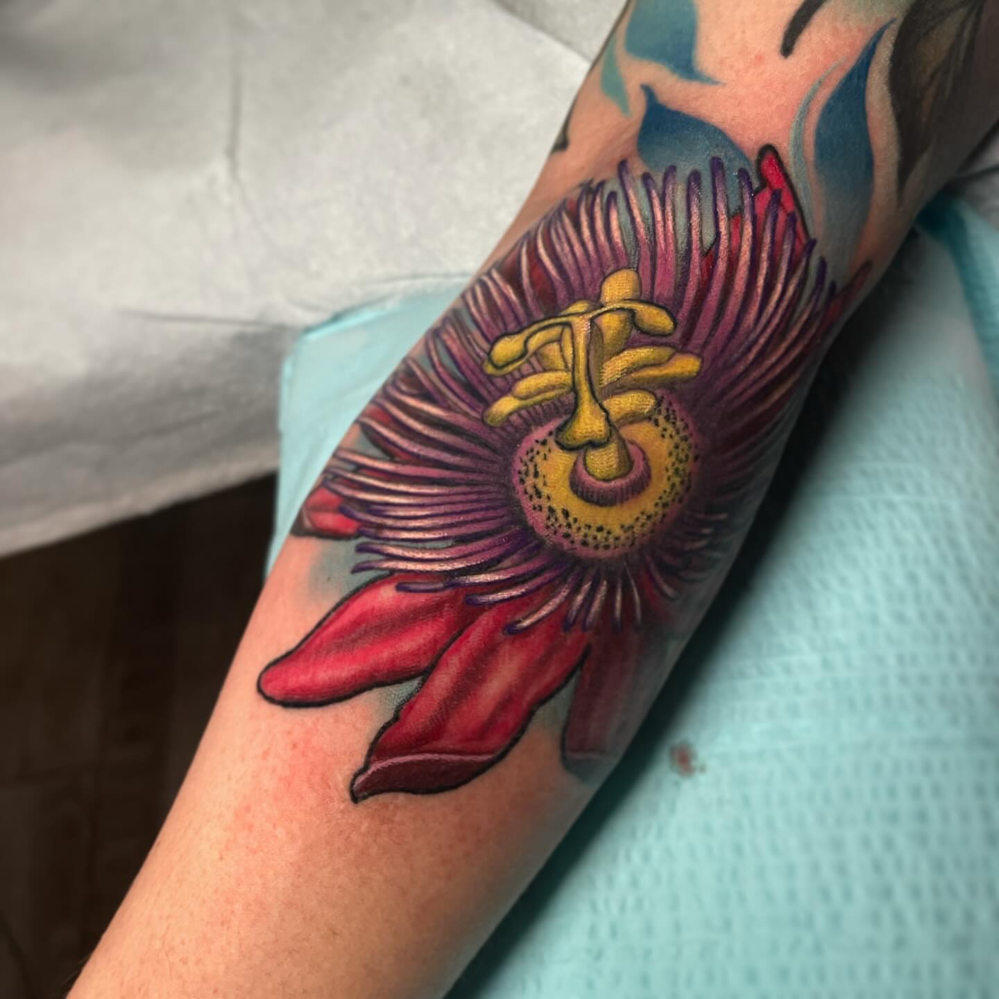 Passion flower realism tattoo on the forearm by Alex Rockoff