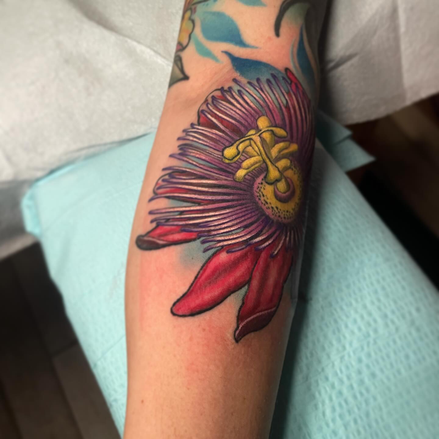 Passion flower realism tattoo on the forearm by Alex Rockoff