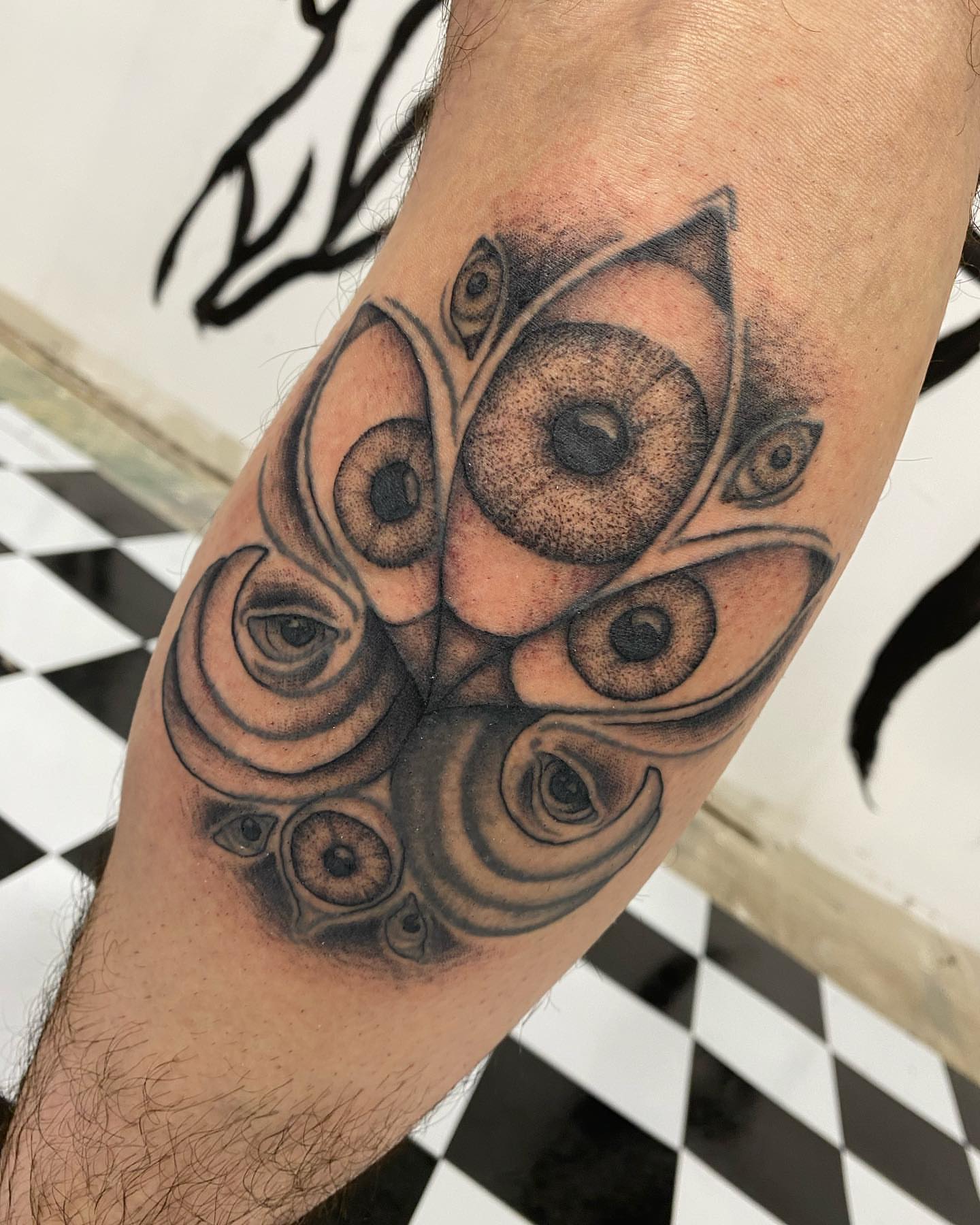Eyes geometric tattoo on the forearm by Savanna Starr Mortensen