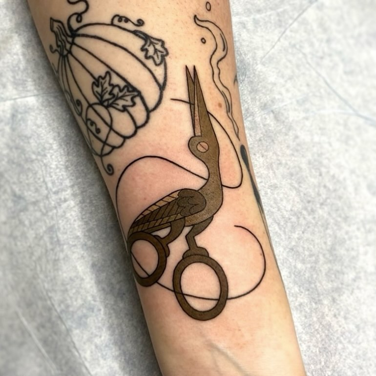 Scissors and bird black and grey tattoo on the forearm by Alicia