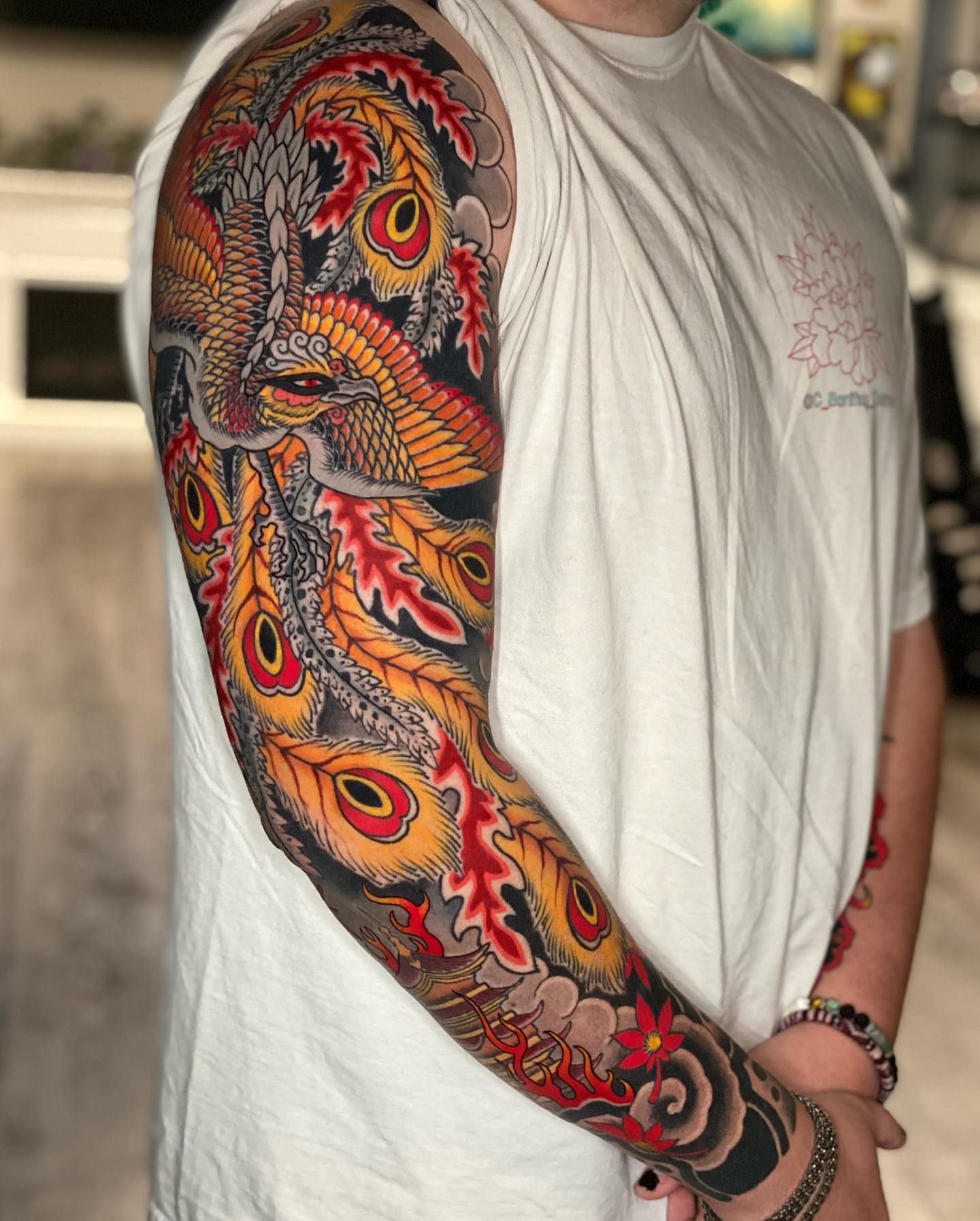 Peacock japanese irezumi tattoo on the upper arm by Mitch Bonifay