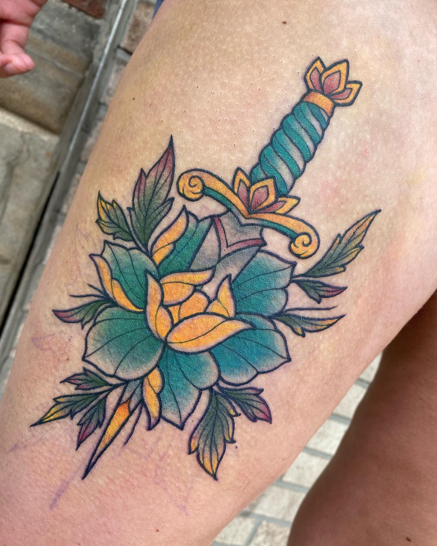 Sword and lotus American traditional tattoo on the thigh by Savanna Starr Mortensen