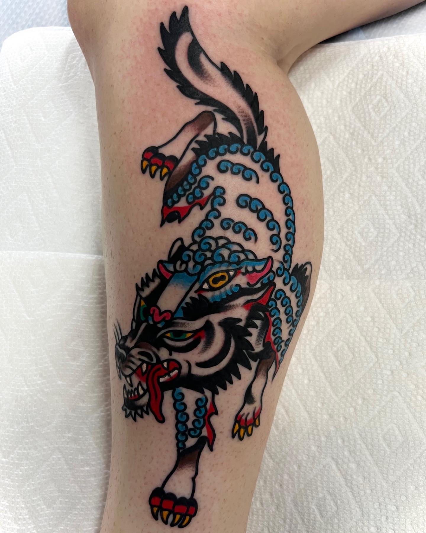 Wolf American traditional tattoo on the leg by Nicholas Mella, Nashville, Tennessee
