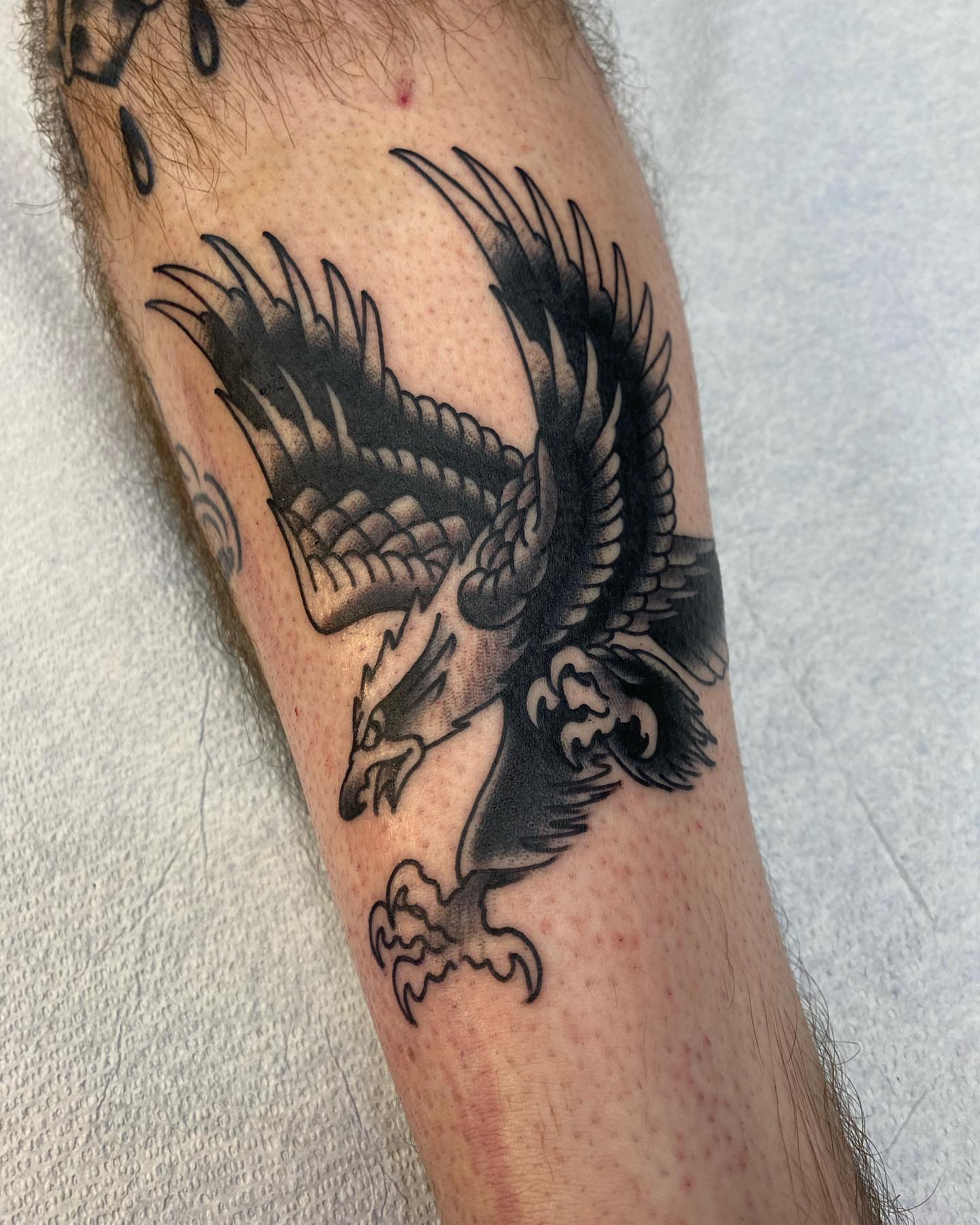 Eagle black and grey tattoo on the forearm by Jesse Ortega