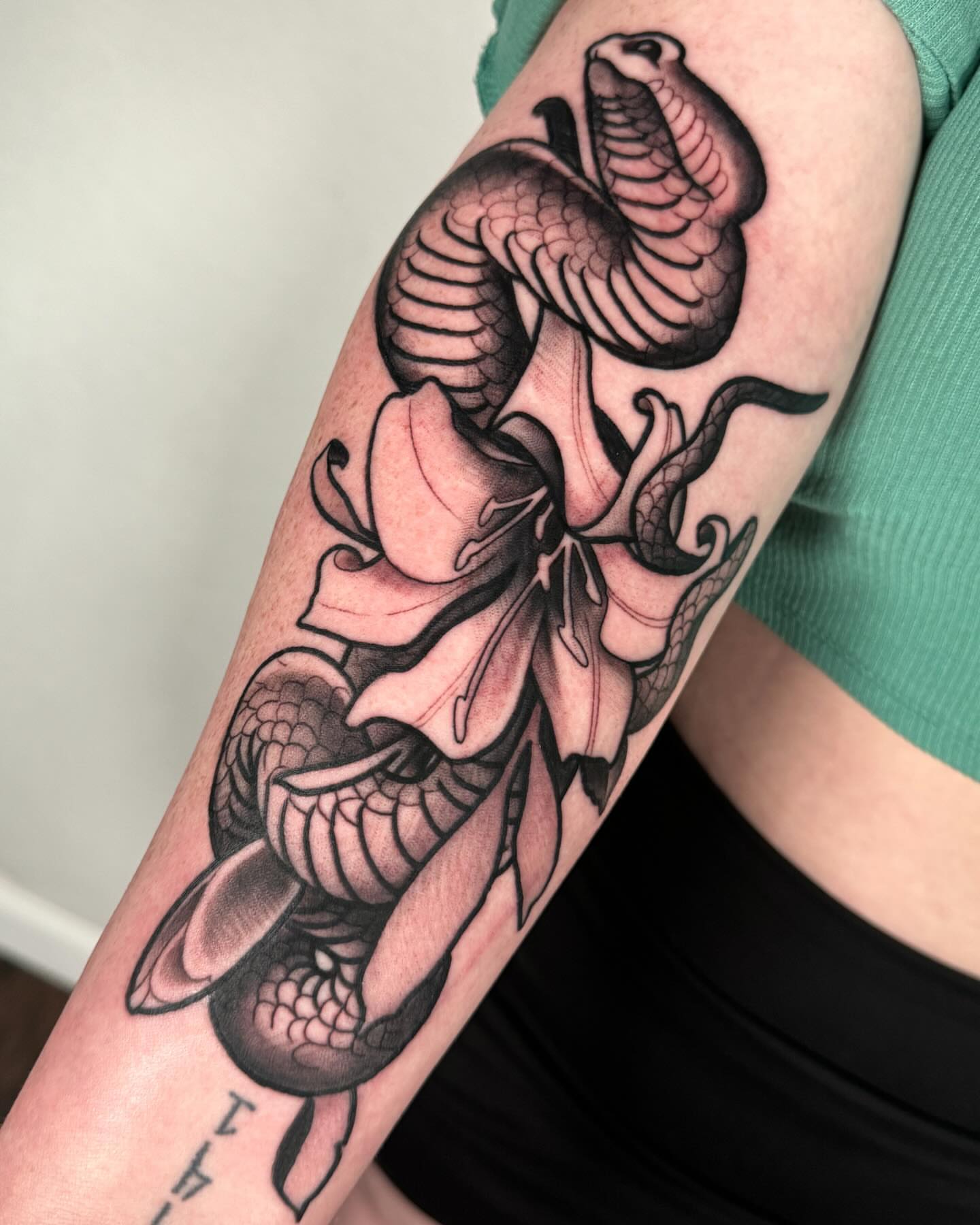 Snake and lily black and grey tattoo on the forearm by ✖️mike Alan✖️