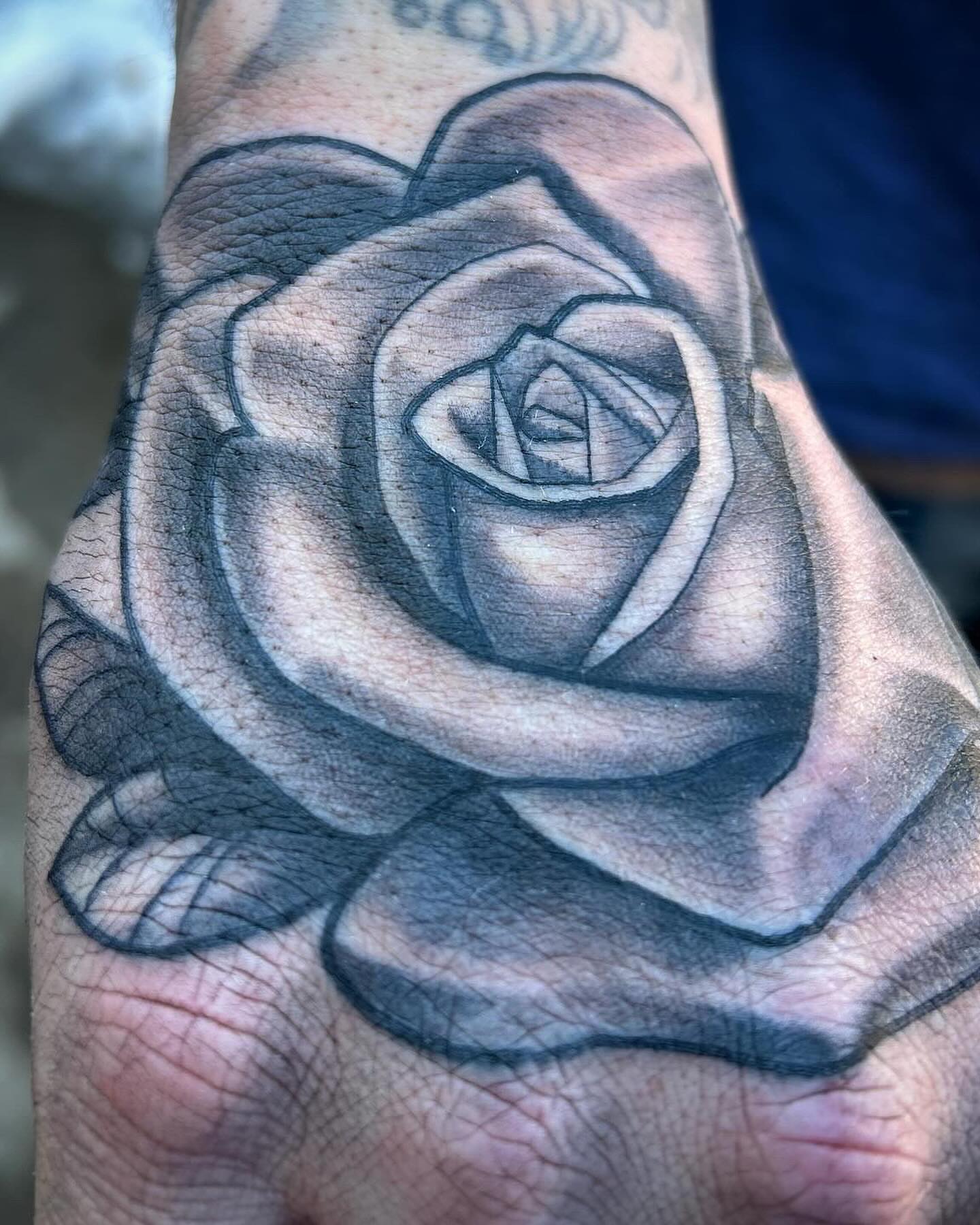 Rose black and grey tattoo on the forearm by Sean Cavanaugh
