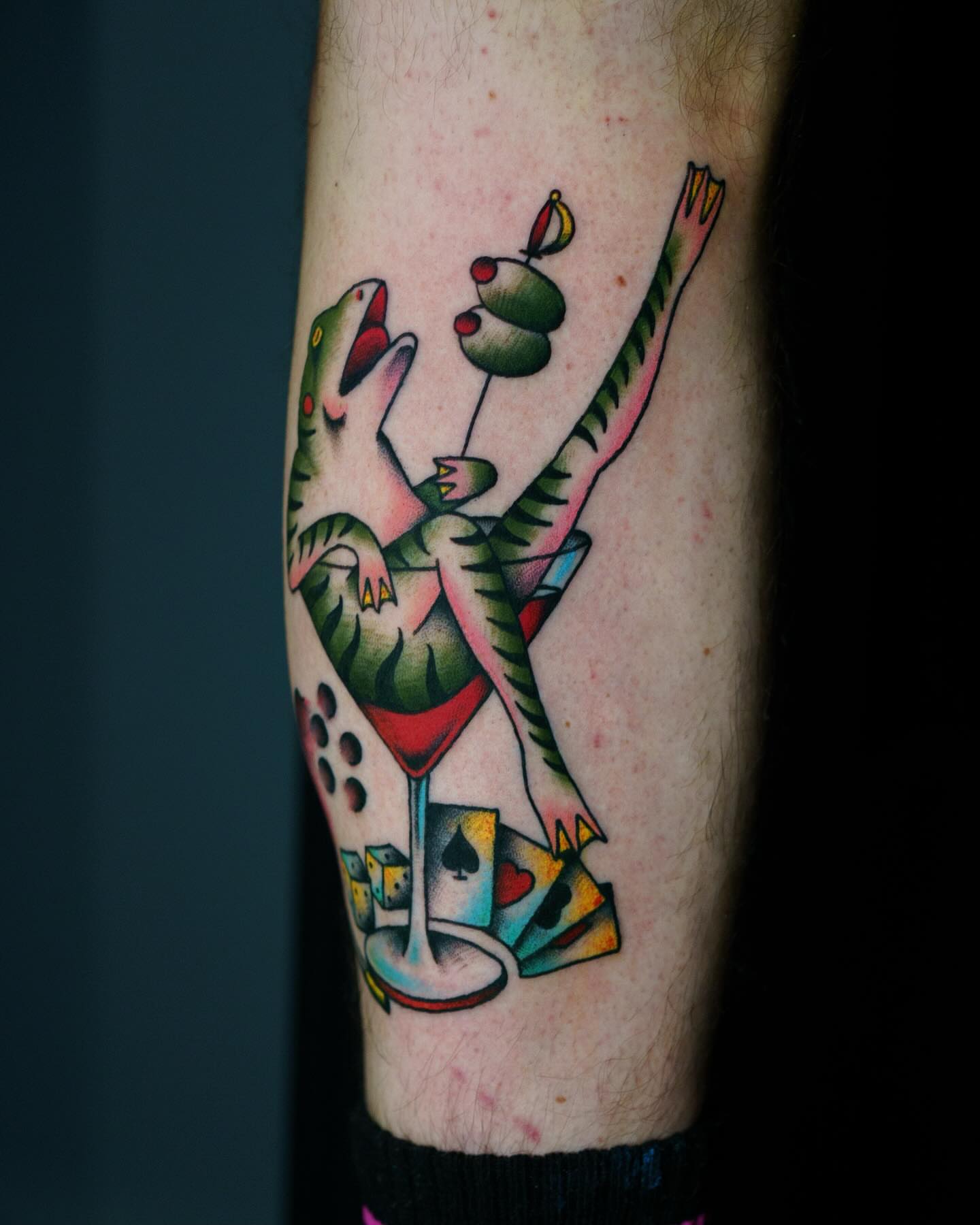 Snake and playing cards American traditional tattoo on the forearm by Nate Masi