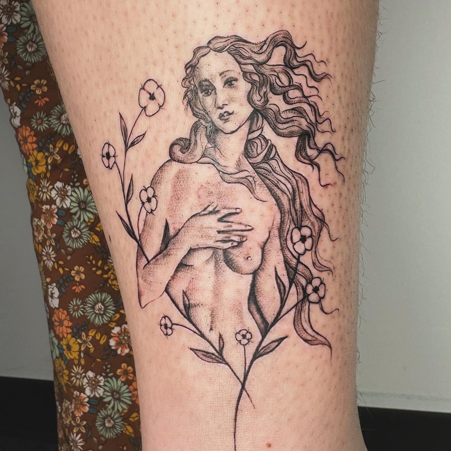 Nude woman with flowers dotwork tattoo on the thigh by RyAnn Lynn