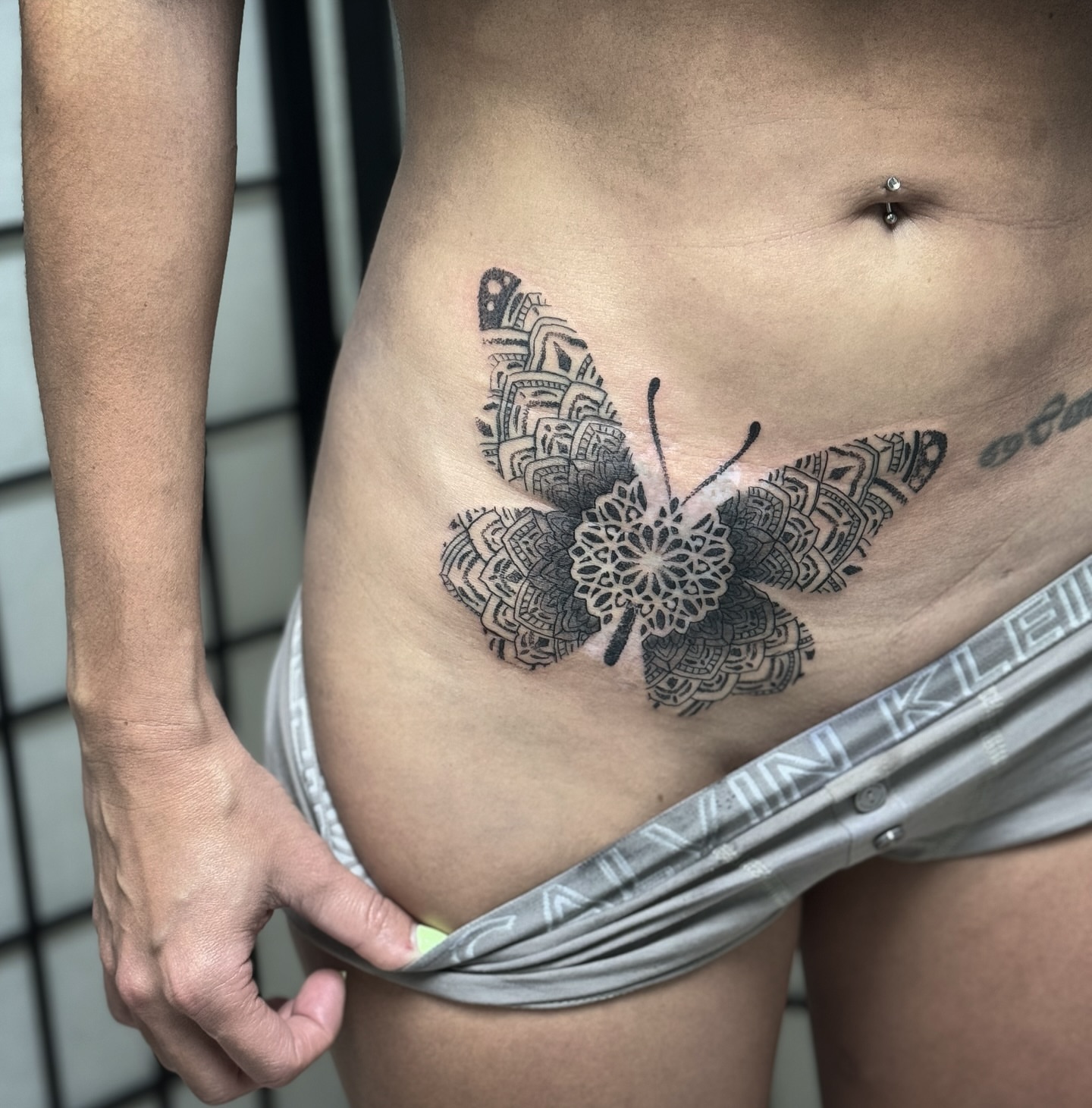 Butterfly geometric tattoo on the ribs by Paul Schnell