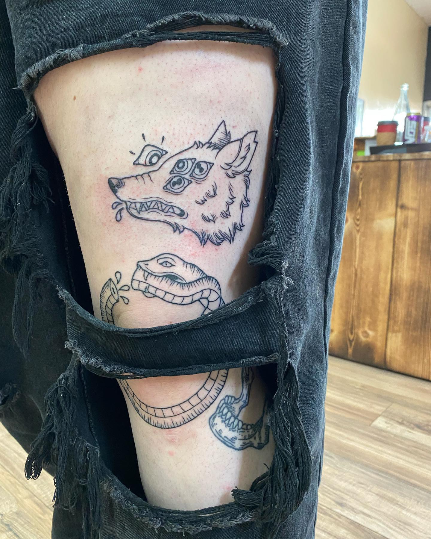 Wolf and snake black and grey tattoo on the thigh by Savanna Starr Mortensen