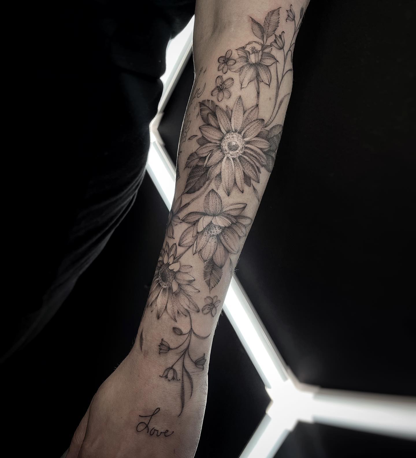 Floral arrangement black and grey tattoo on the forearm by Tattoo Yulia Kononenko