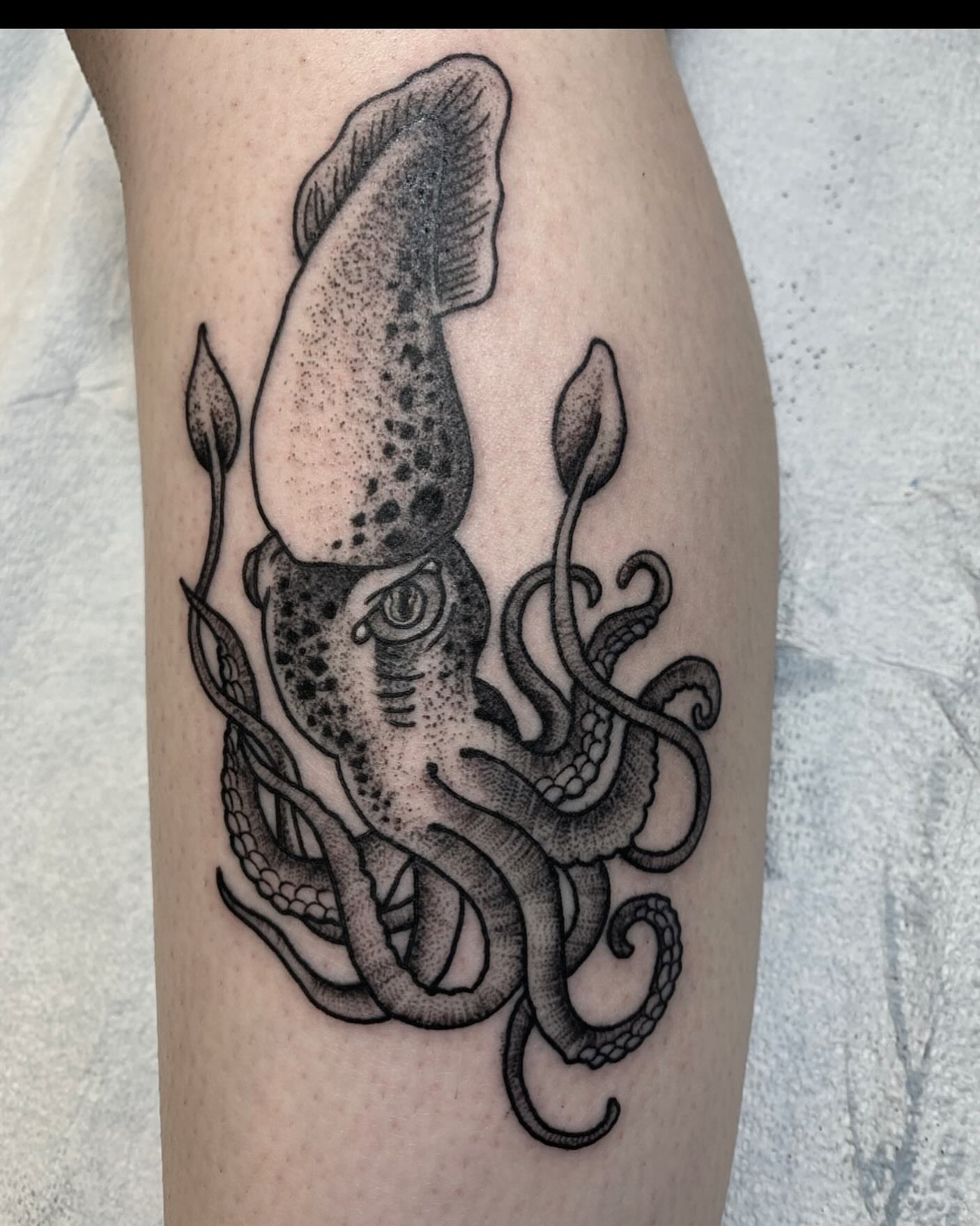 Squid dotwork tattoo on the forearm by Cody Marl