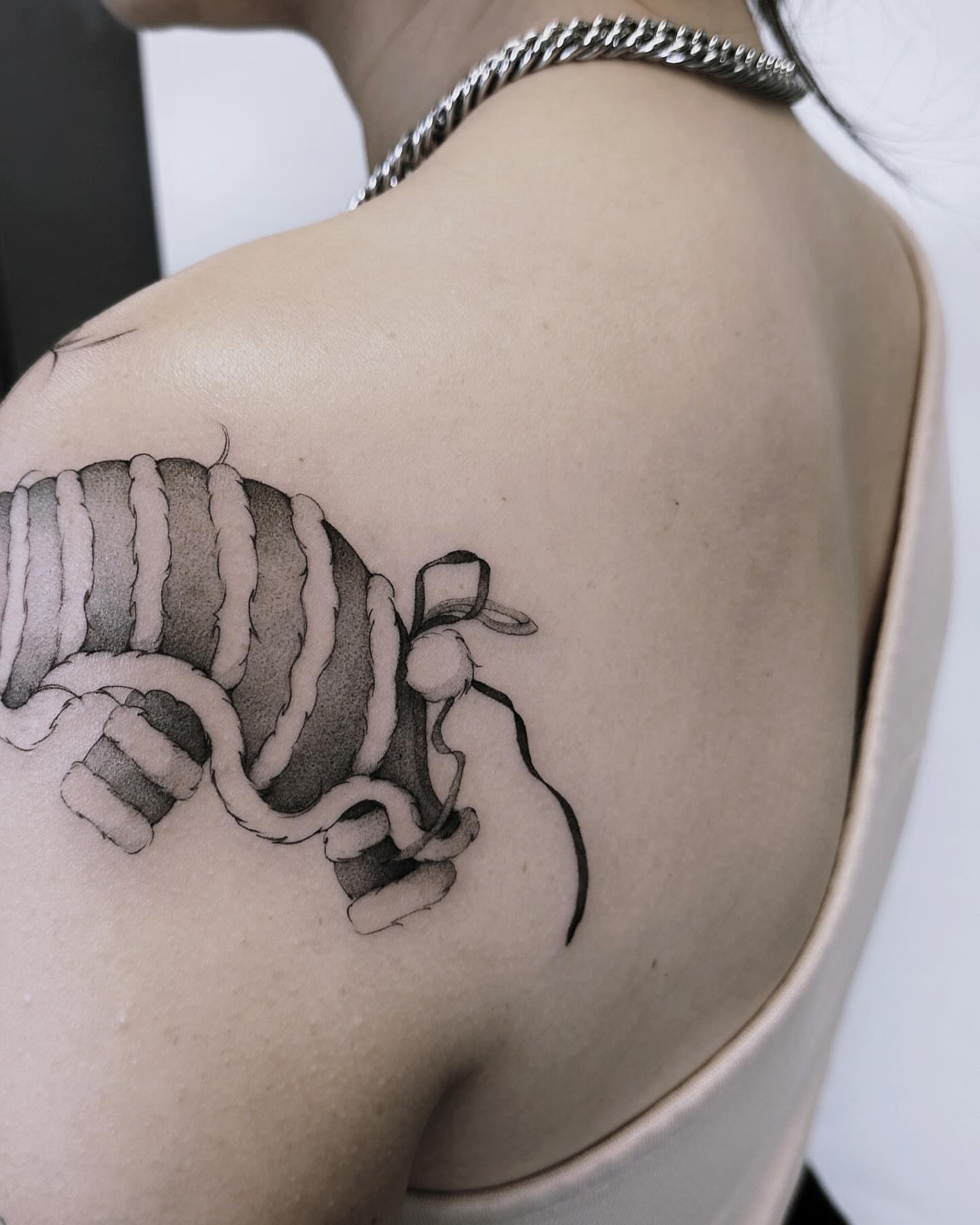 Ball of yarn black and grey tattoo on the shoulder by Angel