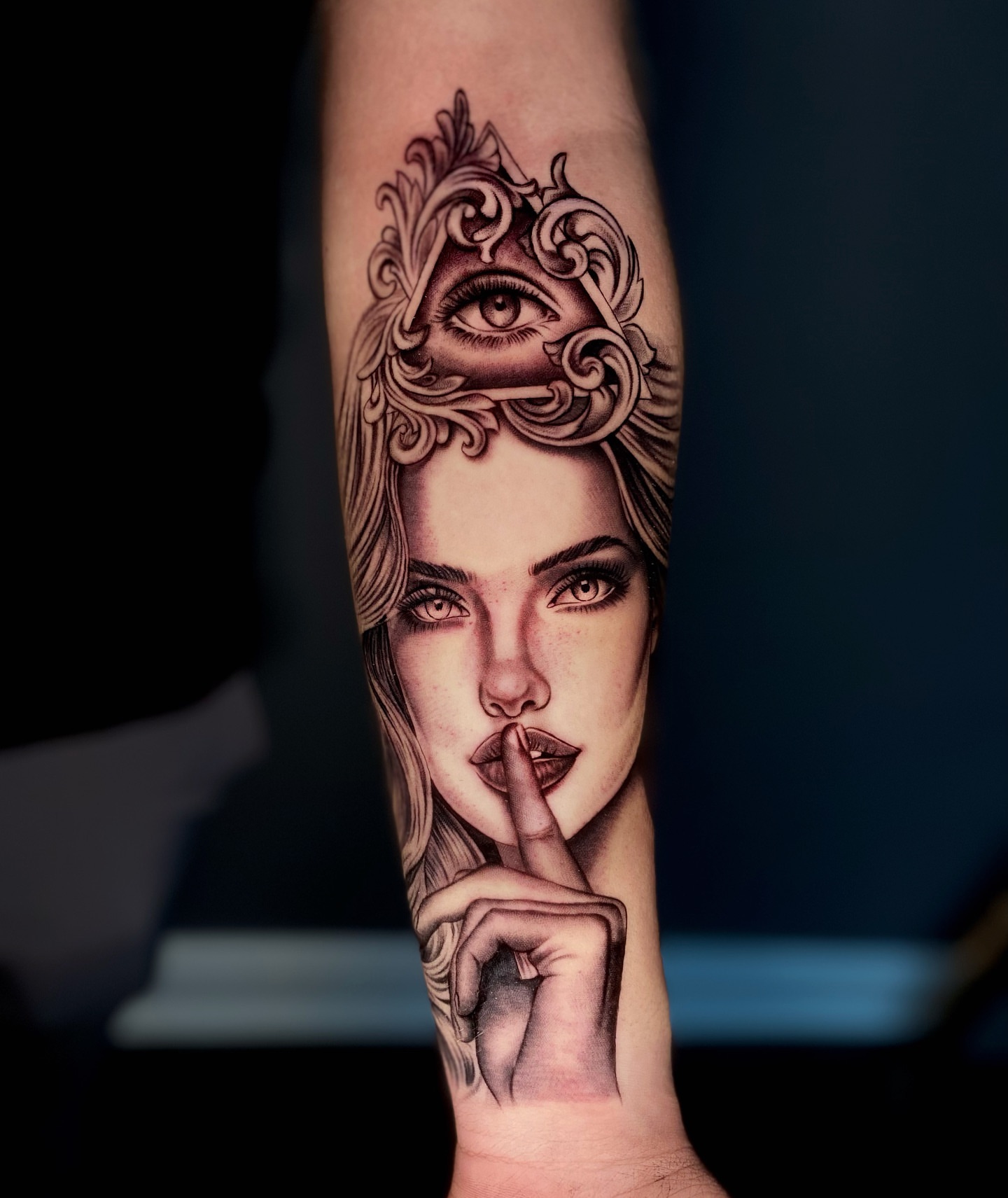 Woman with finger on lips realism tattoo on the forearm by Becky Lee Cameron