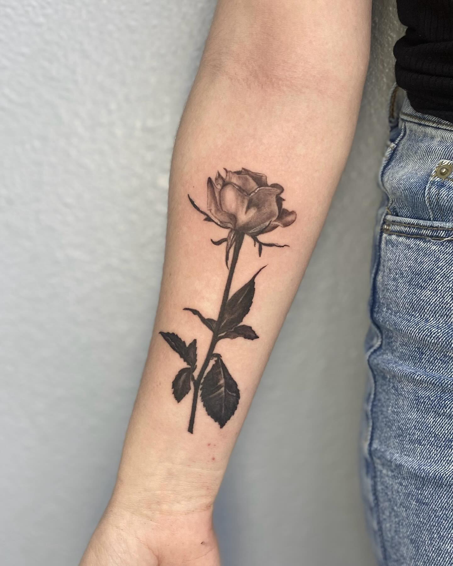 Rose black and grey tattoo on the forearm by jordy
