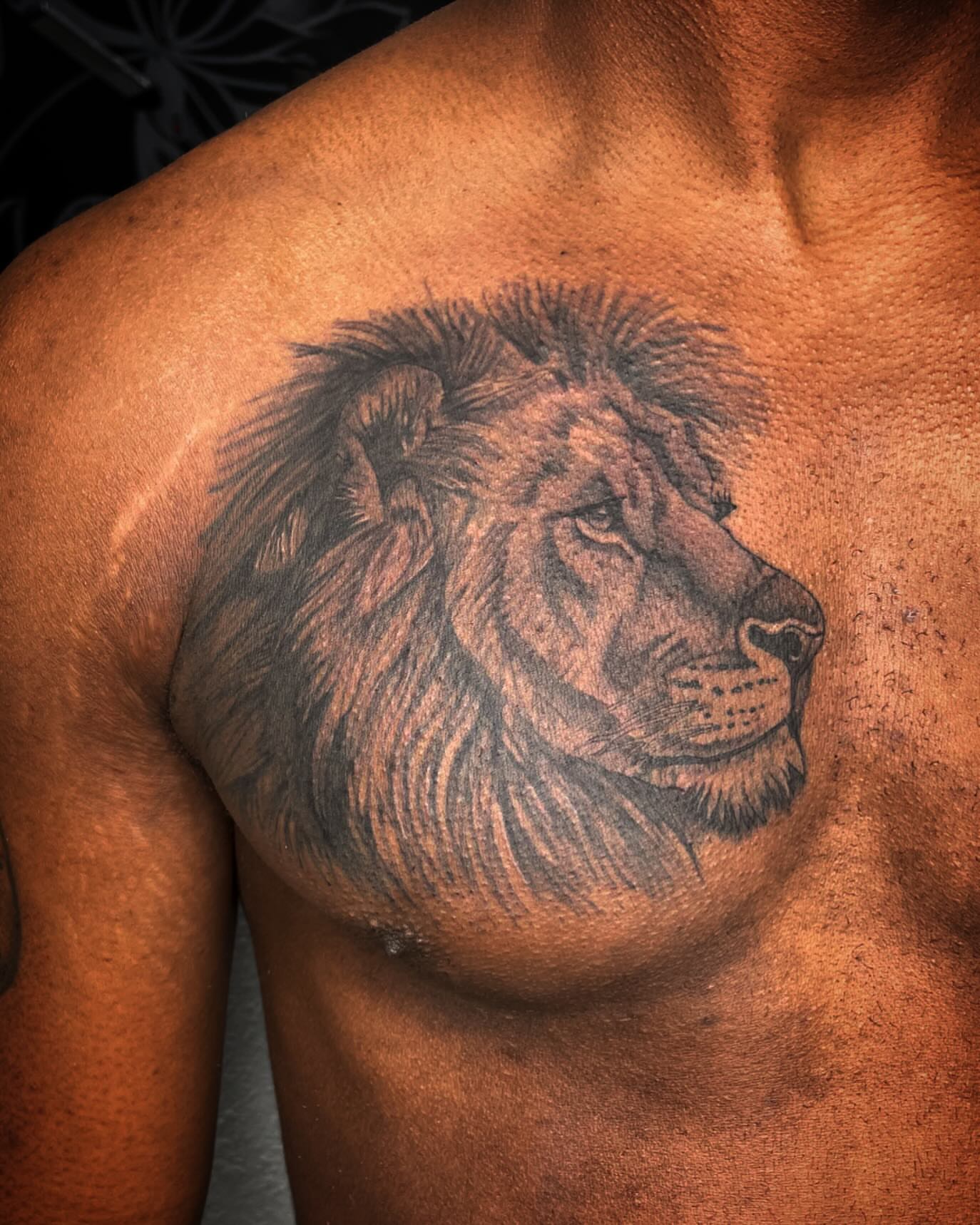 Lion black and grey tattoo on the chest by Las Vegas Tattoo Artist