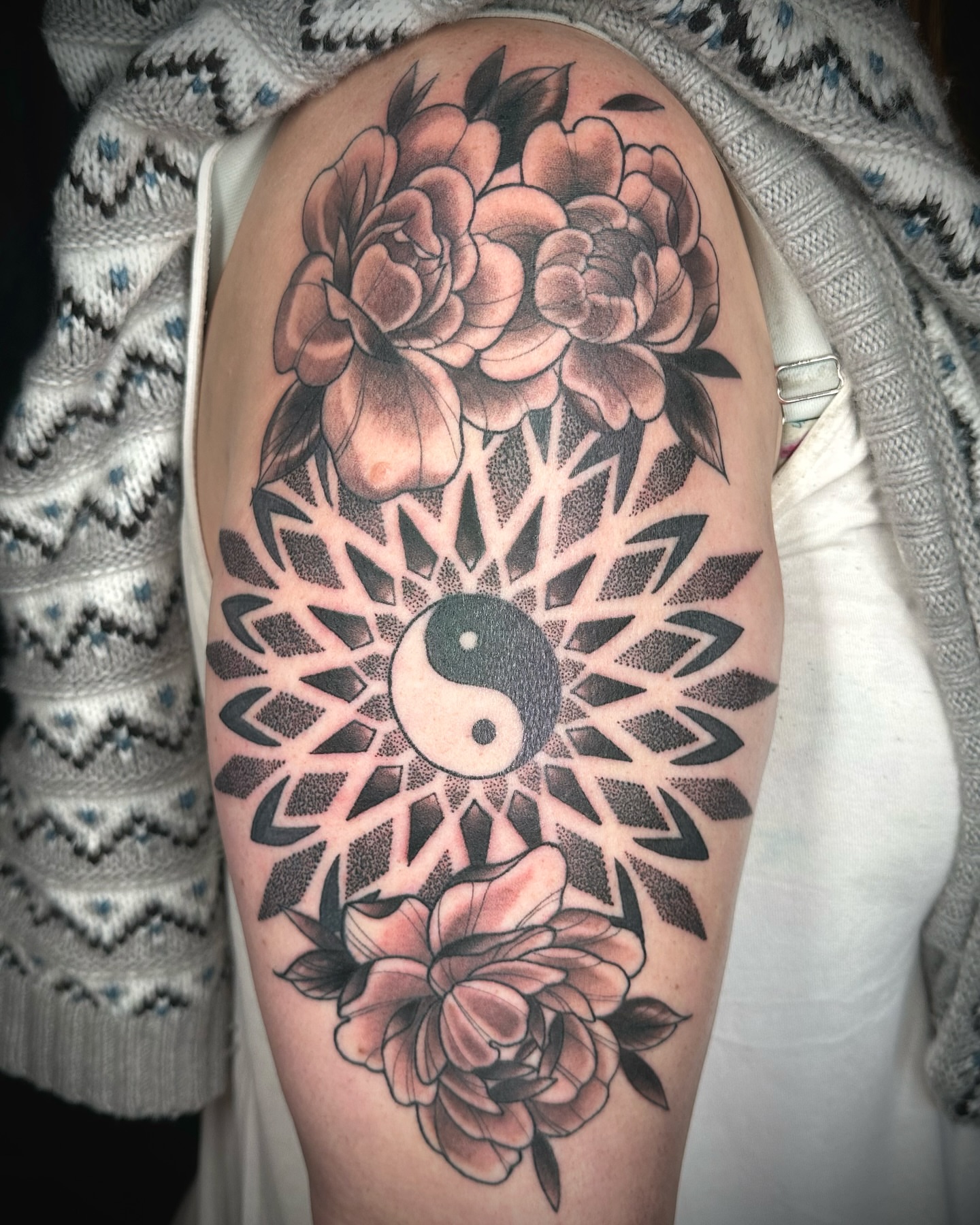 Yin yang and flowers dotwork tattoo on the thigh by B.G. Germershausen