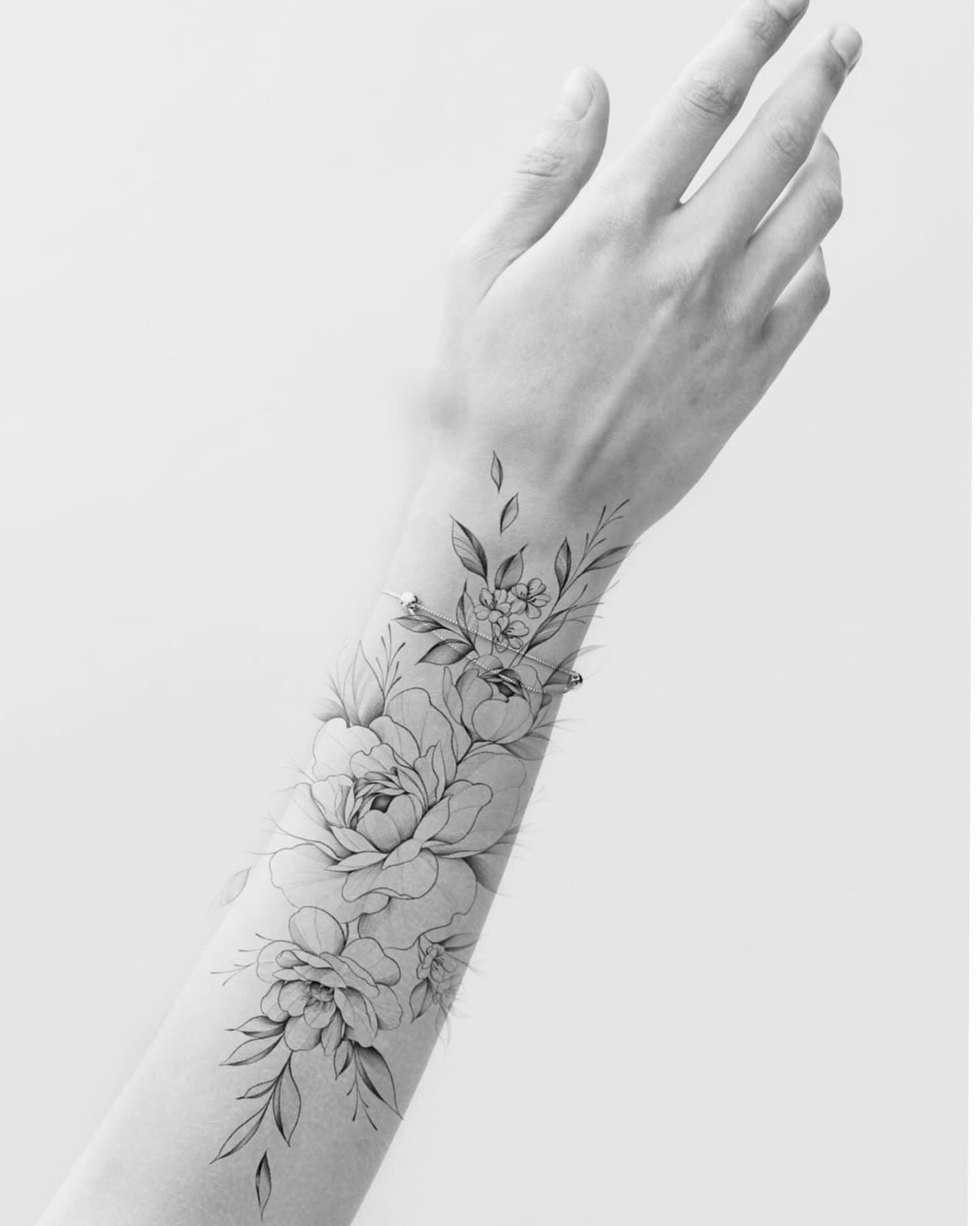 Floral arrangement realism tattoo on the forearm by @katuvetattoo