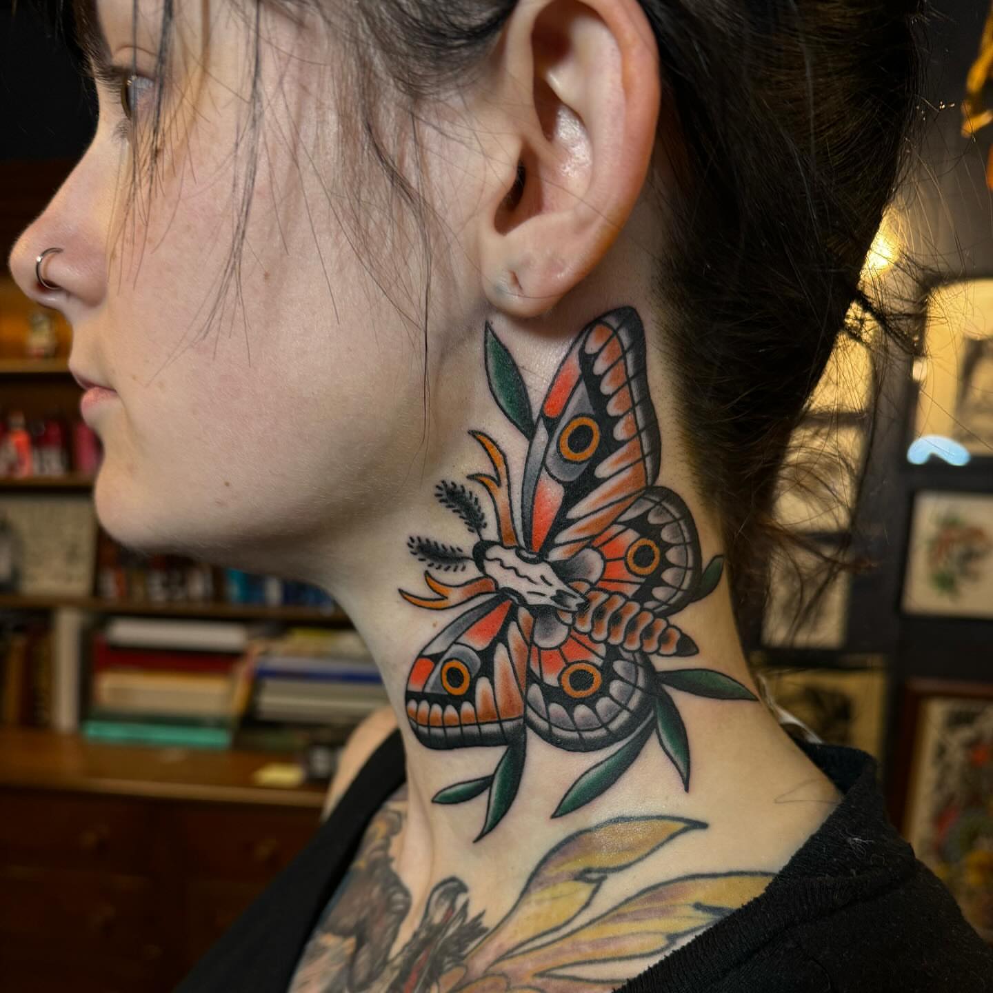 Butterfly American traditional tattoo on the neck by Ethan Bennett