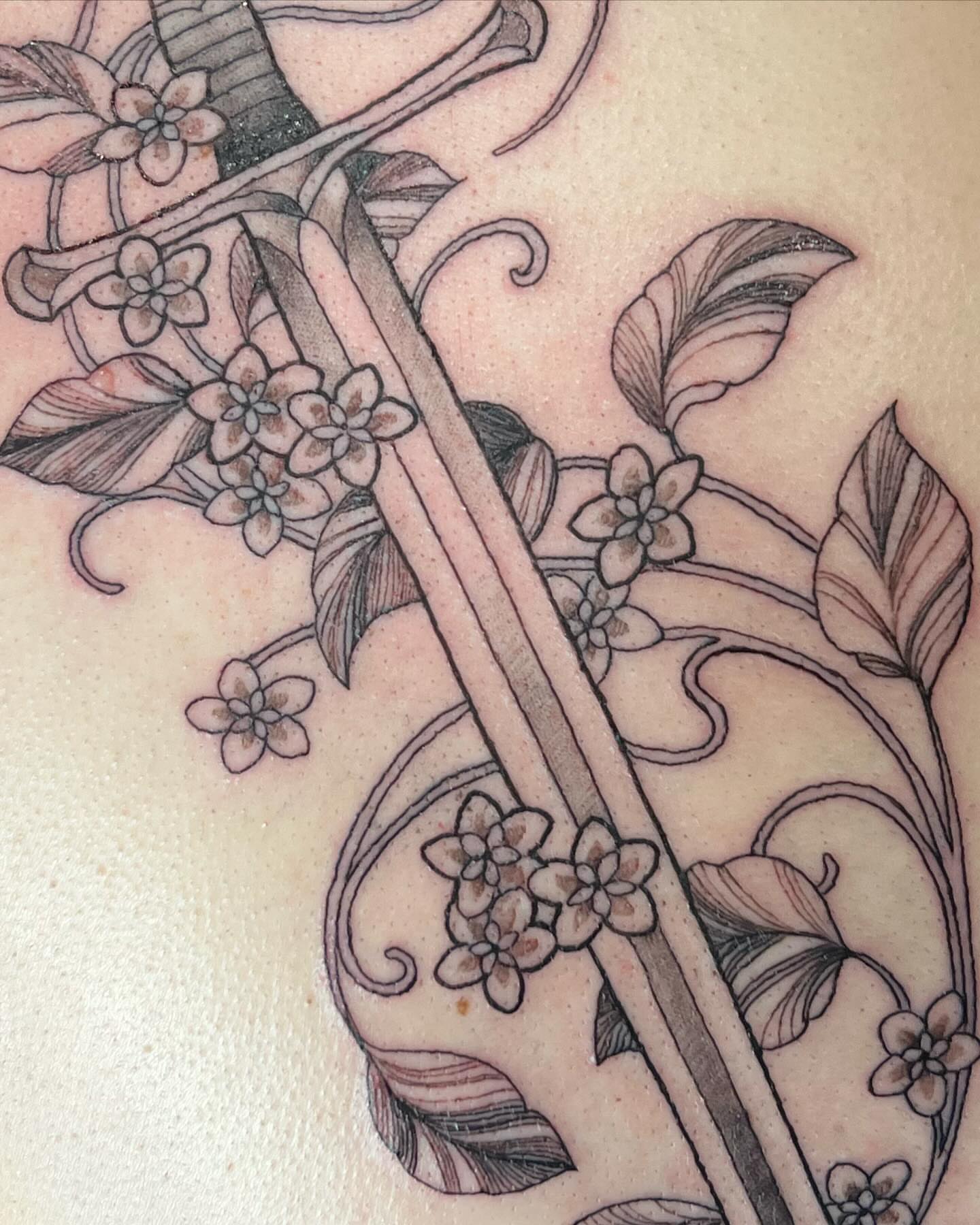 Cherry blossoms and bamboo black and grey tattoo on the upper arm by Tattoos by Alli Wilcox