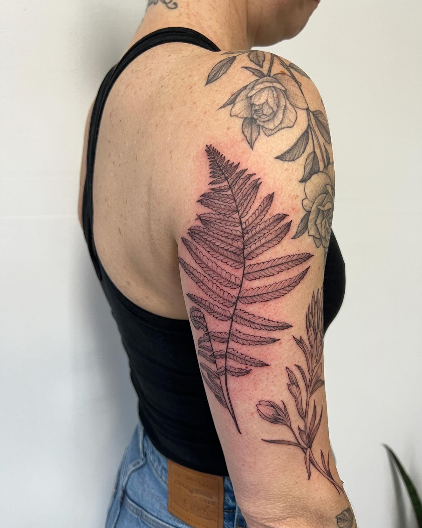 Fern leaf black and grey tattoo on the upper arm by See See : botanical tattoo artist :