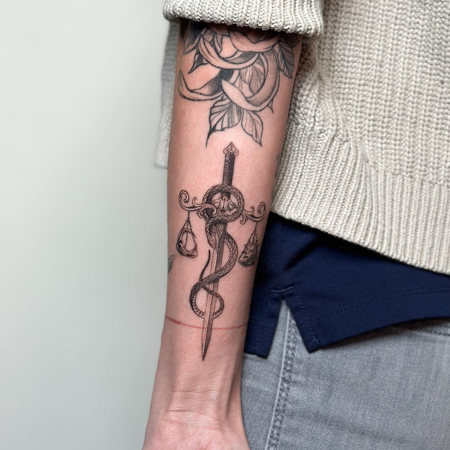 Sword and snake black and grey tattoo on the forearm by Valery Cardona
