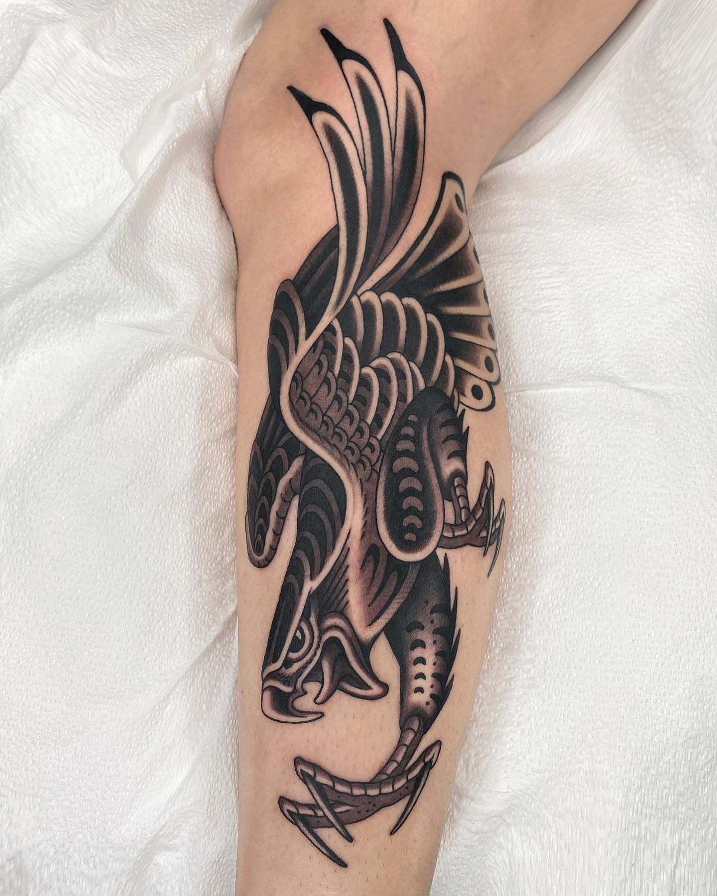 Dragon black and grey tattoo on the forearm by Wes Hoffman