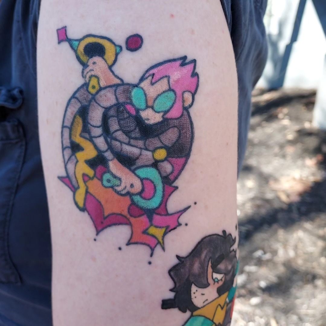 Snake and heart new school tattoo on the forearm by Spike Cameron