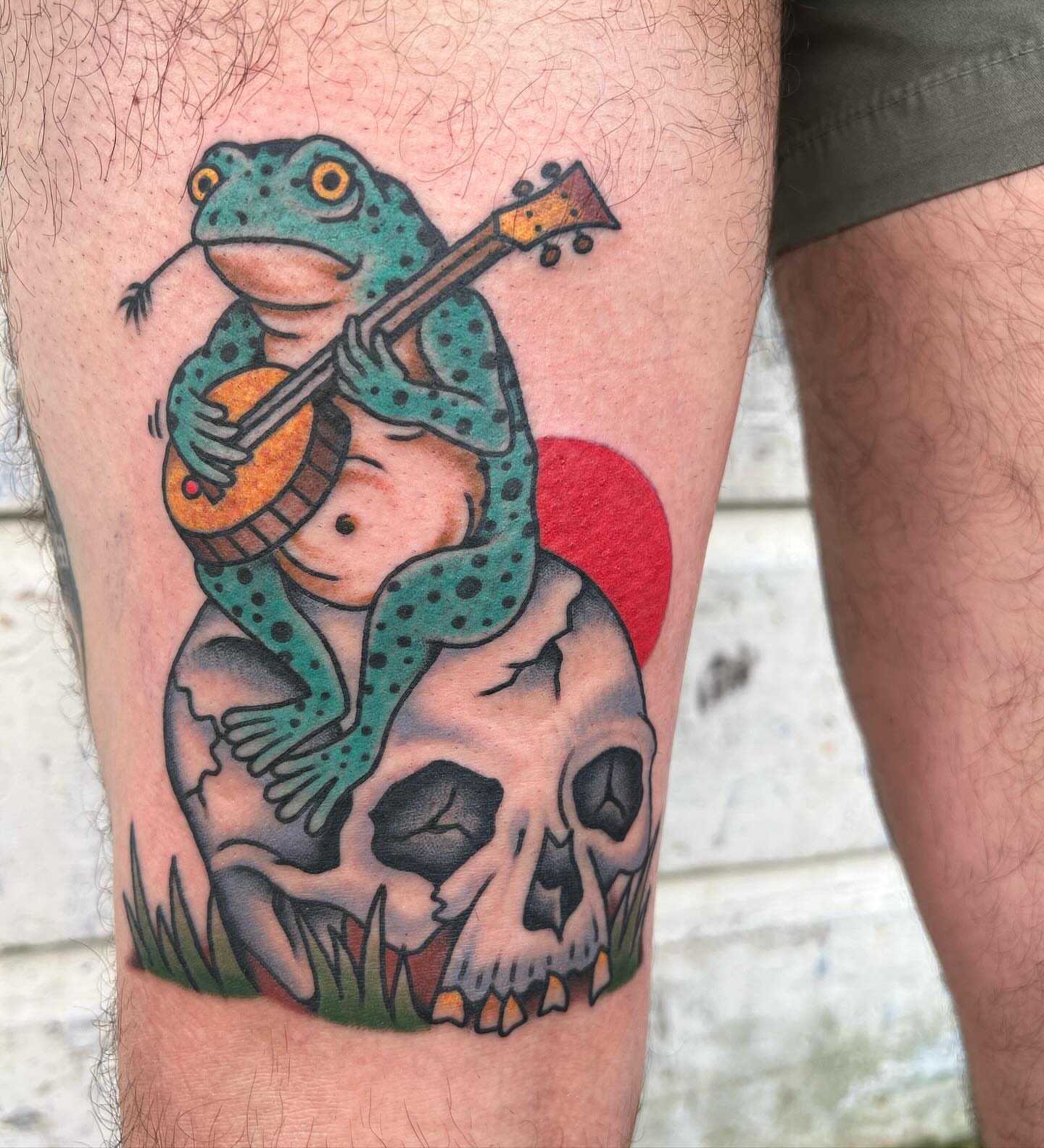 Frog playing guitar American traditional tattoo on the thigh by Ross K. Jones Tattoos, San Francisco, California