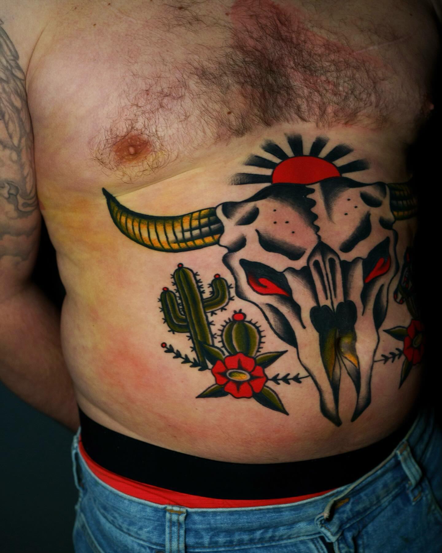 Bull skull with cactus American traditional tattoo on the ribs by Nate Masi