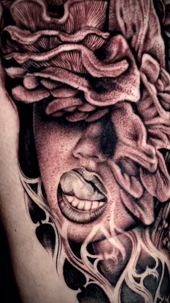 Distorted face with floral elements dark realism tattoo by Las Vegas tattoo Artist