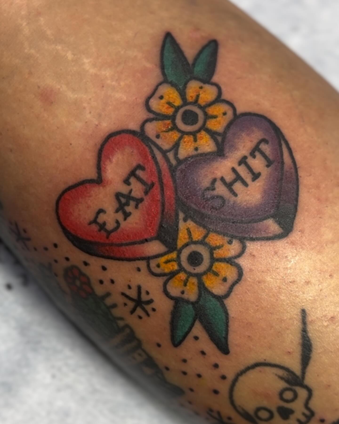 Heart and flower American traditional tattoo on the forearm by Minneapolis
