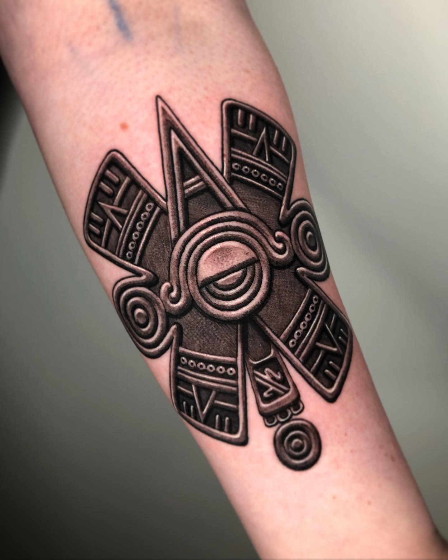 Ancient mask black and grey tattoo on the forearm by David Torres