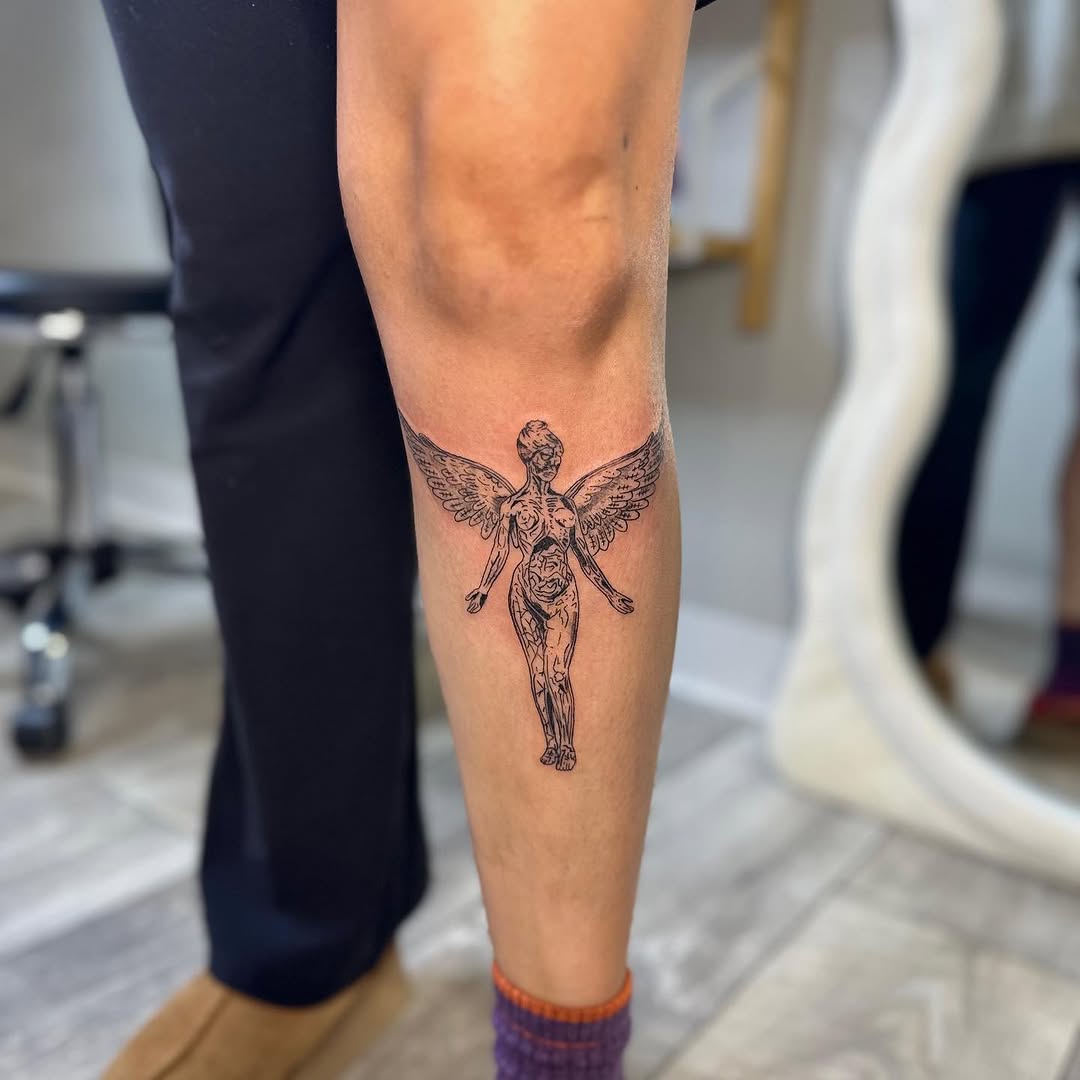 Winged figure realism tattoo on the calf by brinley - fine line tattoos, Crescent Springs, Kentucky