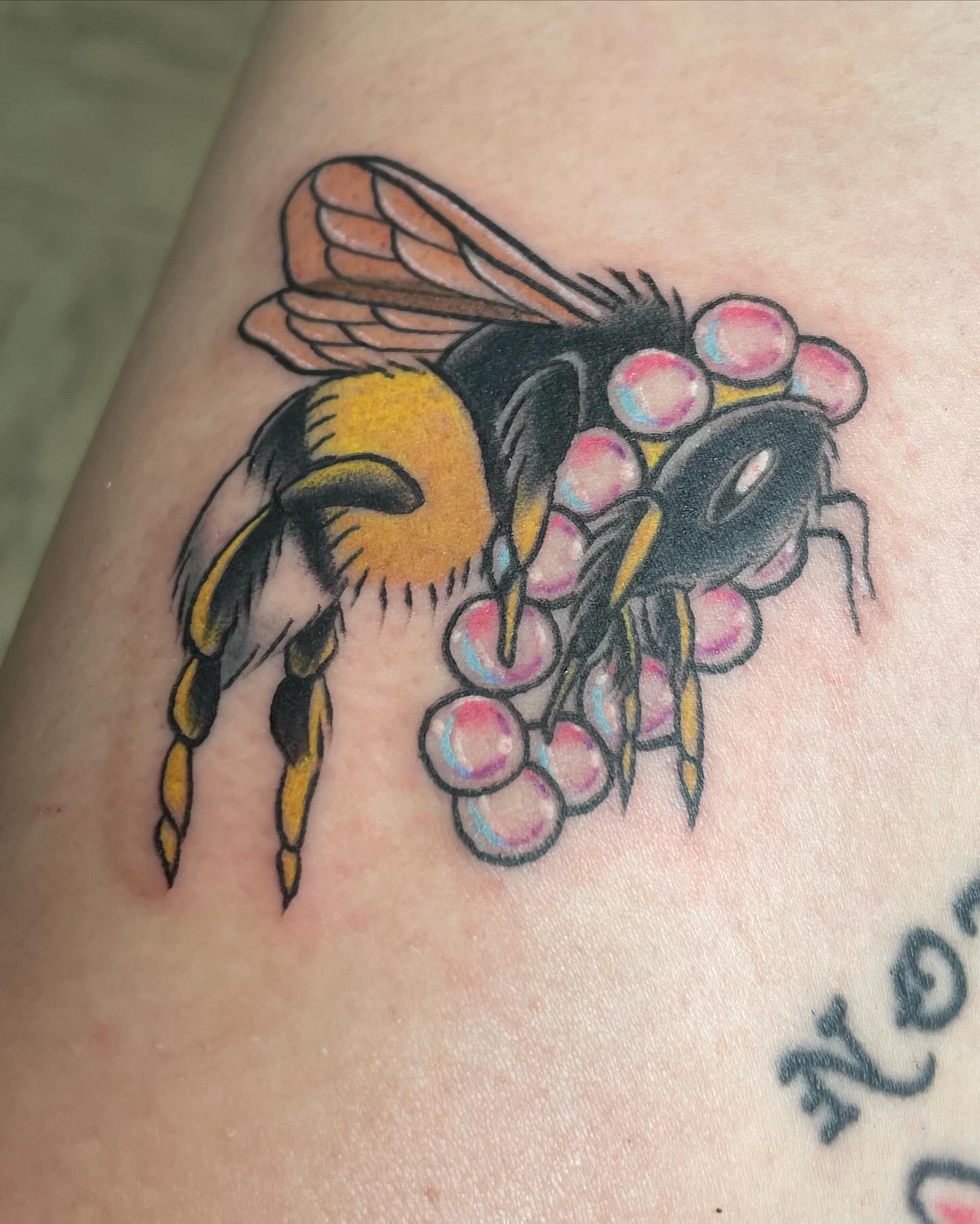 Bumblebee American traditional tattoo on the upper arm by Michelle