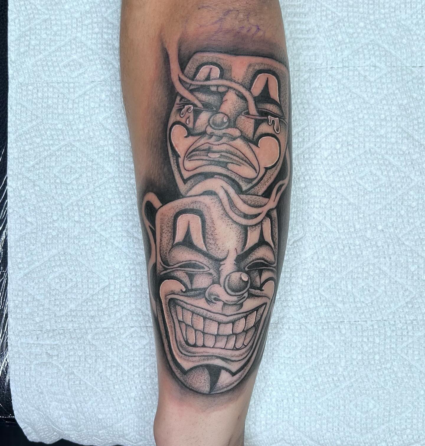 Mask dotwork tattoo on the forearm by Colby McClain
