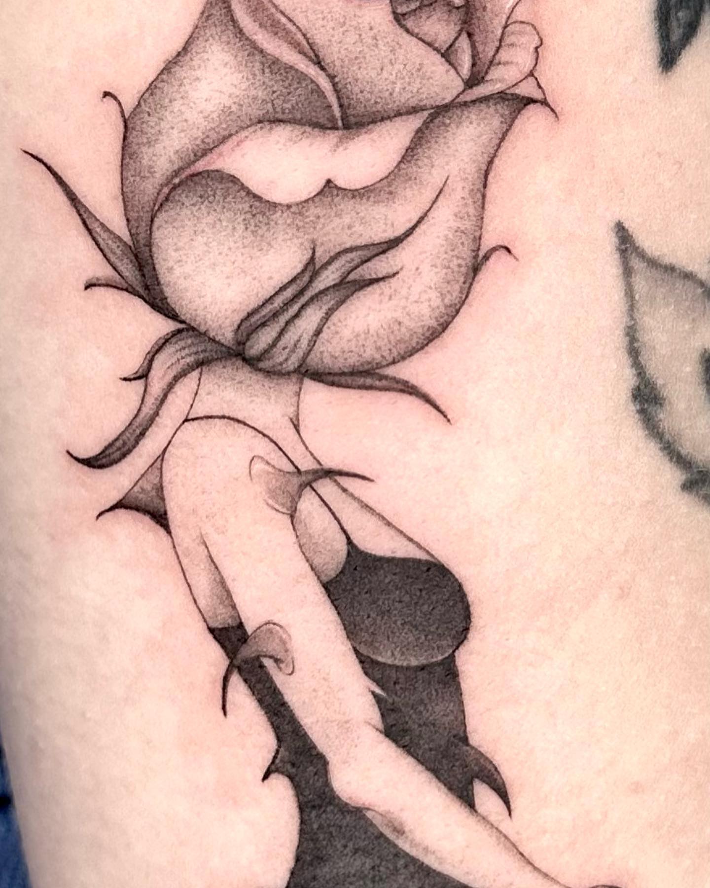 Rose black and grey tattoo on the forearm by Sophia Delfino