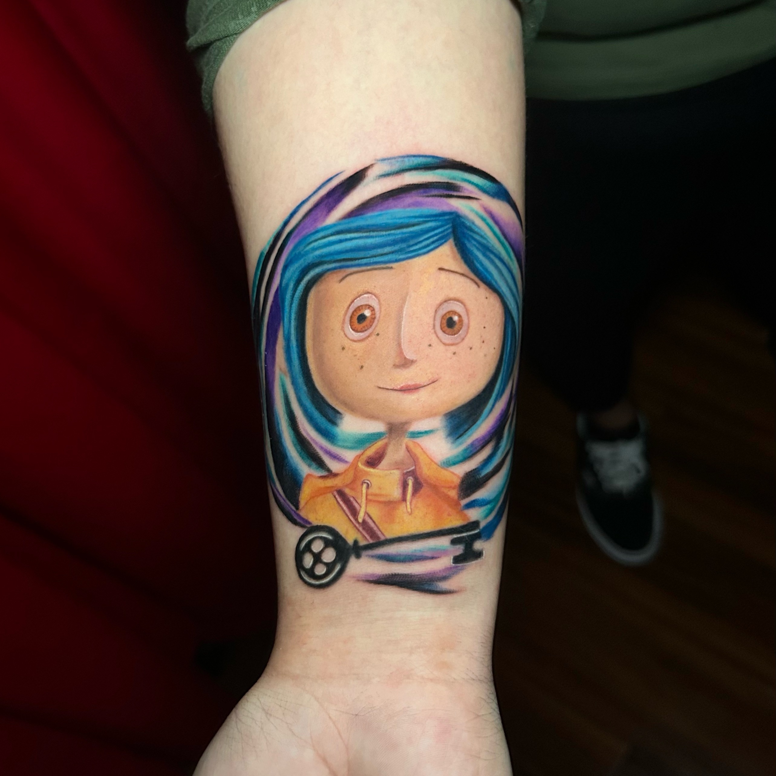 Coraline realism tattoo on the forearm by Tiffany Bauer