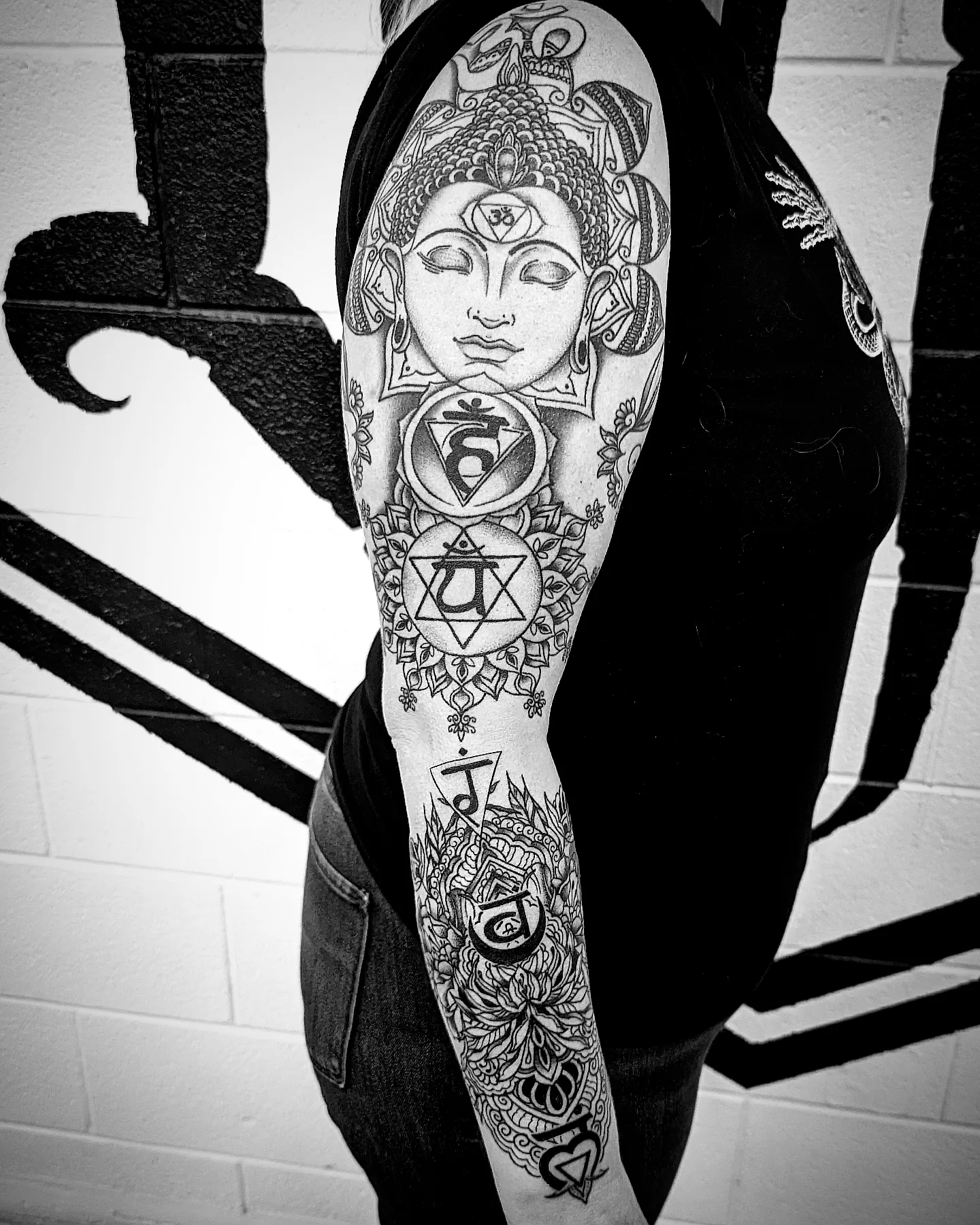 Mandala with deity geometric tattoo on the forearm by Krista Mc