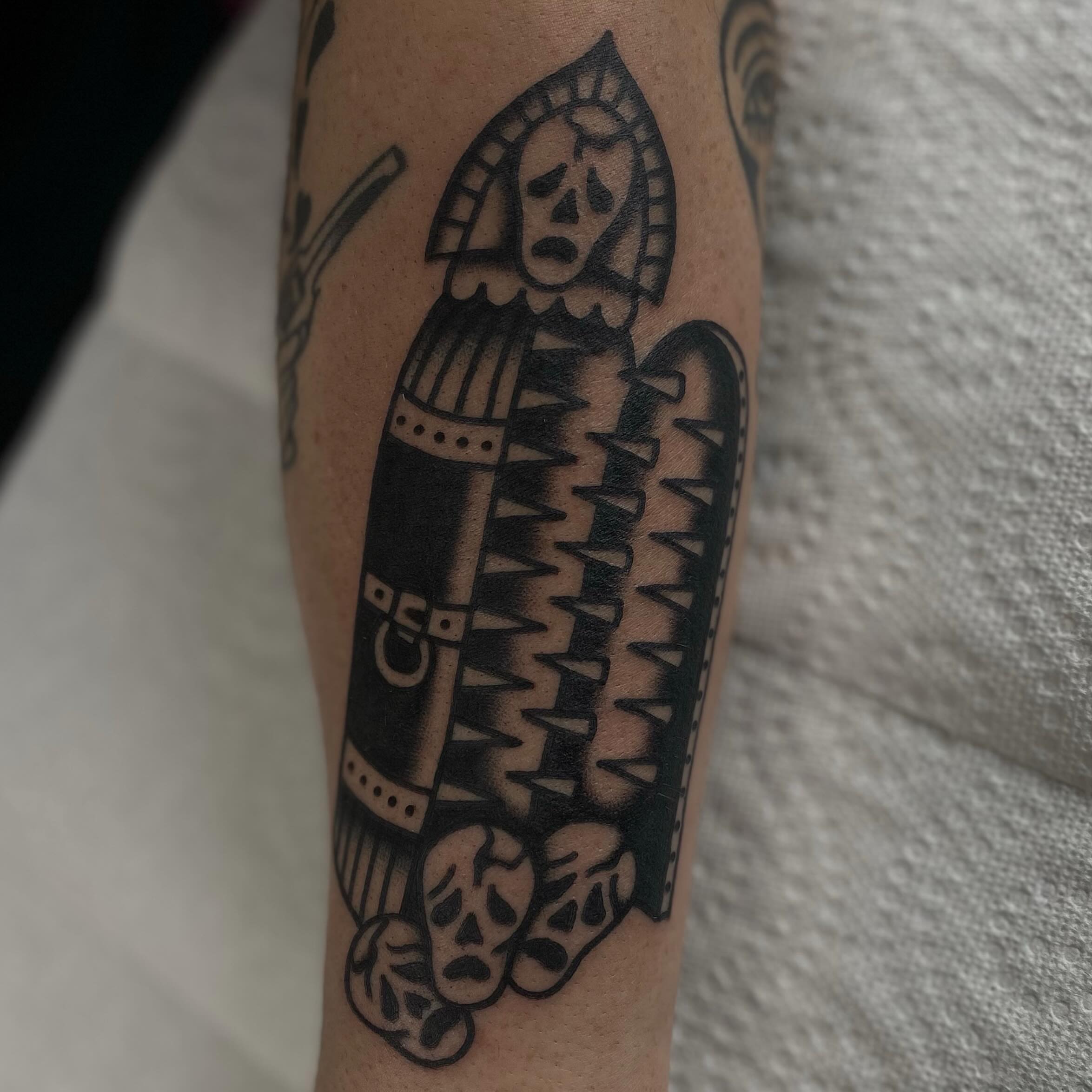 Military armor black and grey tattoo on the forearm by Erin Chambers