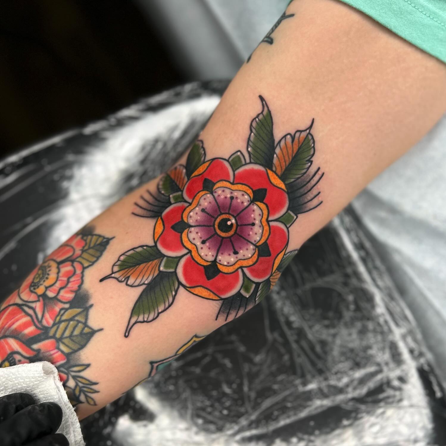 Floral bouquet American traditional tattoo on the forearm by Noah Crow