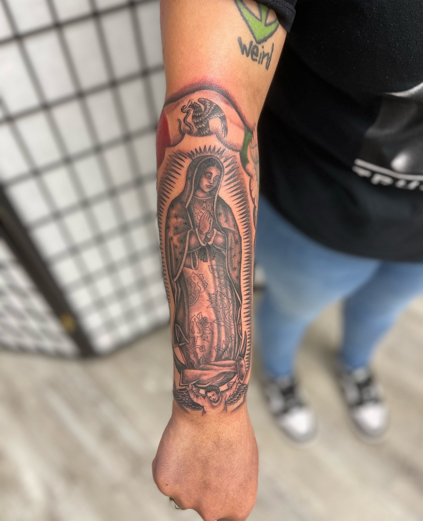 Our Lady of Guadalupe black and grey tattoo on the forearm by Mister Joe Joe Frisco Tattoo, San Francisco, California