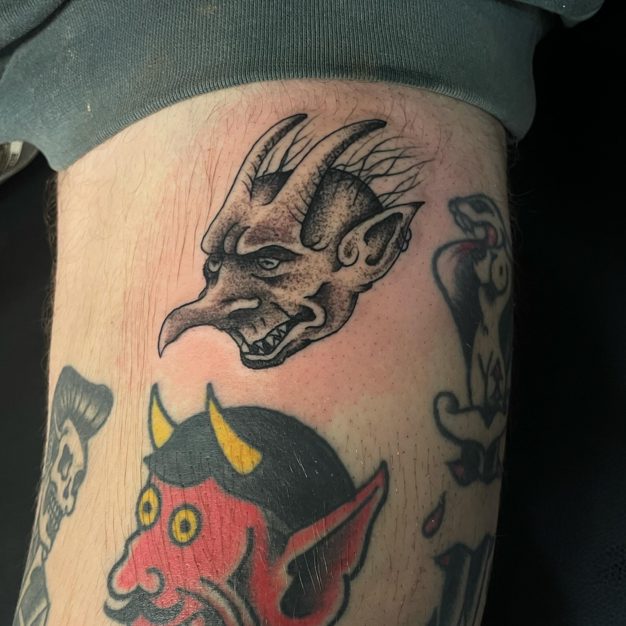 Demon head American traditional tattoo on the thigh by Kimberly Shordon