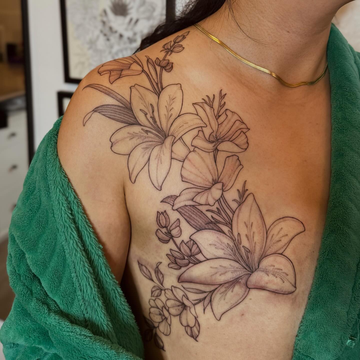 Lilies and flowers black and grey tattoo on the shoulder by 𝘉𝘢𝘺 𝘈𝘳𝘦𝘢 𝘛𝘢𝘵𝘵𝘰𝘰 𝘈𝘳𝘵𝘪𝘴𝘵, Oakland, California