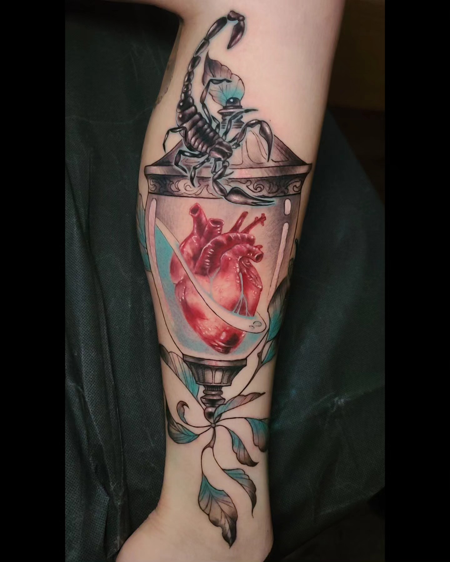 Heart in glass realism tattoo on the forearm by Rain Delmar